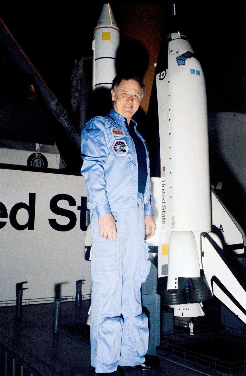 Candid views, Astronaut Donald L. Lind posing with the Shuttle Model and Payload Flight Assignment, Bldg. 9A, 03/10/1983.    1.  EXHIBITS - SHUTTLE MODEL                     JSC, HOUSTON, TX