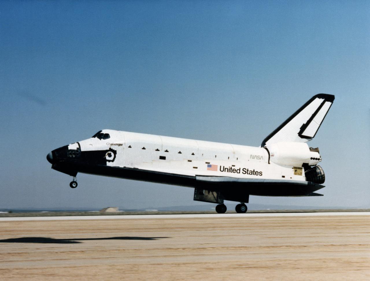 S83-30220 (9 April 1983) --- The space shuttle Challenger makes its first landing shortly before 11 a.m. (PST) on April 9, 1983, on Runway 22 at the Edwards Air Force Base in Southern California. Onboard the reusable spacecraft, having just completed a successful five-day mission, are astronauts Paul J. Weitz, Karol J. Bobko, F. Story Musgrave and Donald H. Peterson. Photo credit: NASA