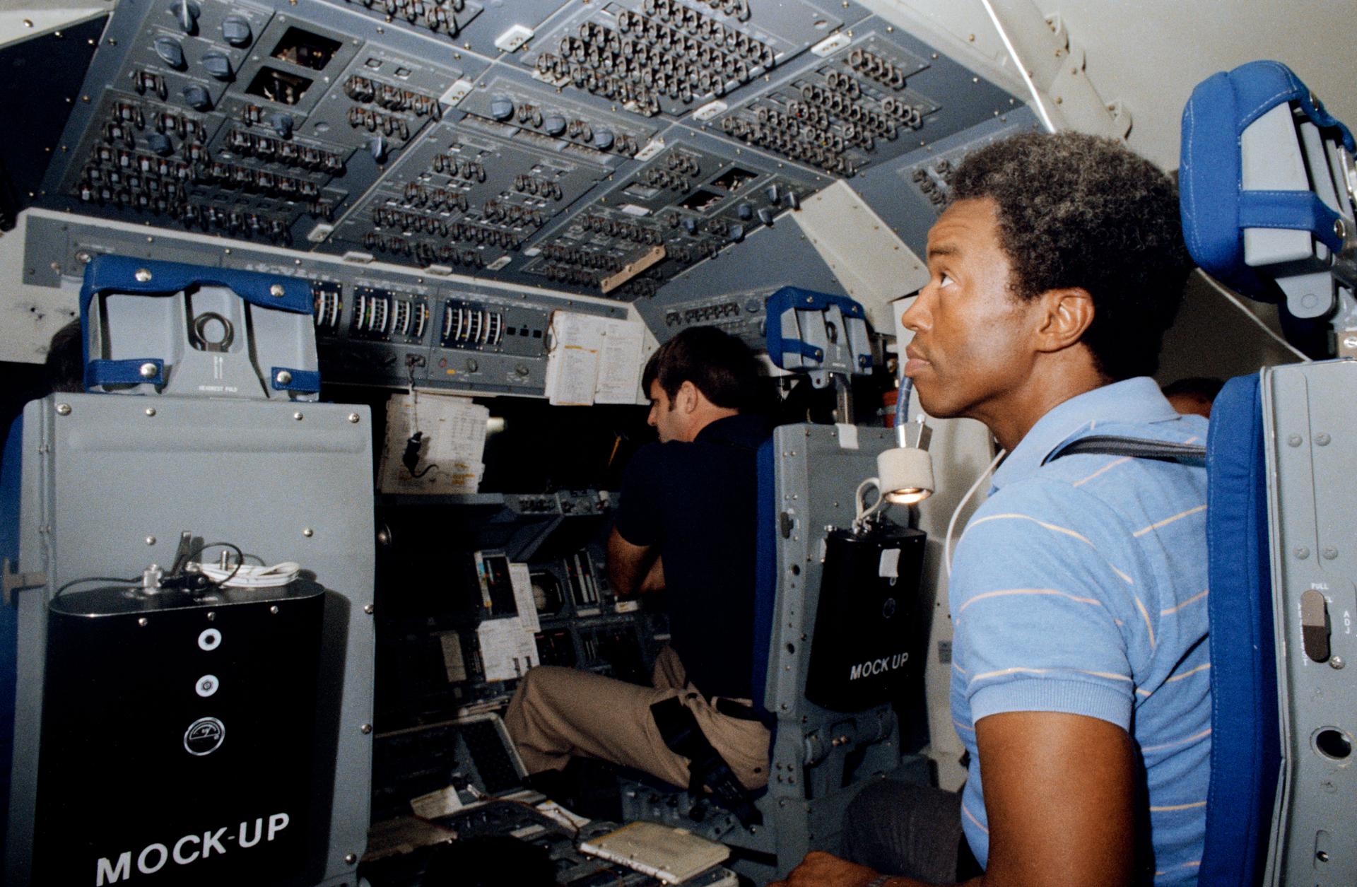 Guy Bluford and his STS-8 crewmembers train for their flight in a simulator.