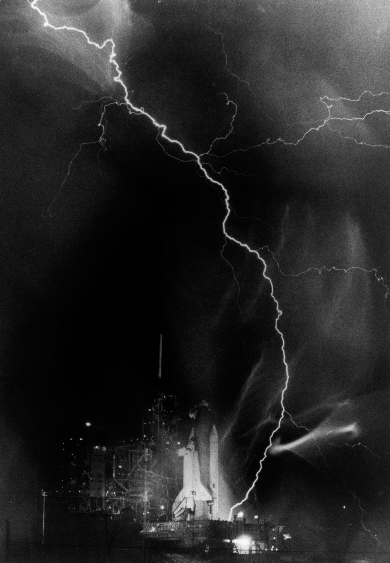 Lightning across the sky with Shuttle at launch pad on 08/30/1983