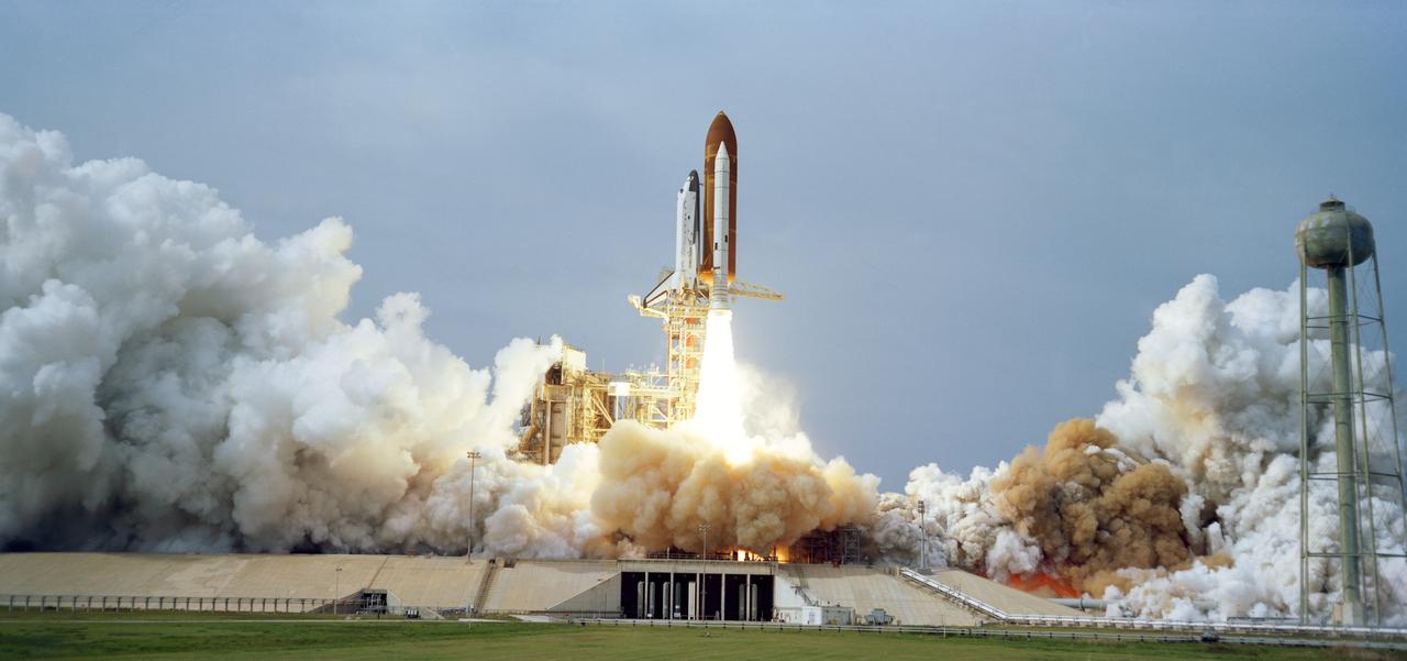 S83-44997 (28 Nov 1983) --- The Columbia lifts off once again from launch pad 39A at the Kennedy Space Center to begin a busy nine days in space for six crewmembers. Official launch time was 11:00:00:84 a.m. (EST). Onboard the spacecraft are Astronauts John W. Young, Brewster Shaw, Jr., Dr. Owen K. Garriott, Dr. Robert A. R. Parker; the European Space Agency?s Dr. Ulf Merbold; and Dr. Byron K. Lichtenberg, biomedical engineer with Massachusetts Institute of Technology.