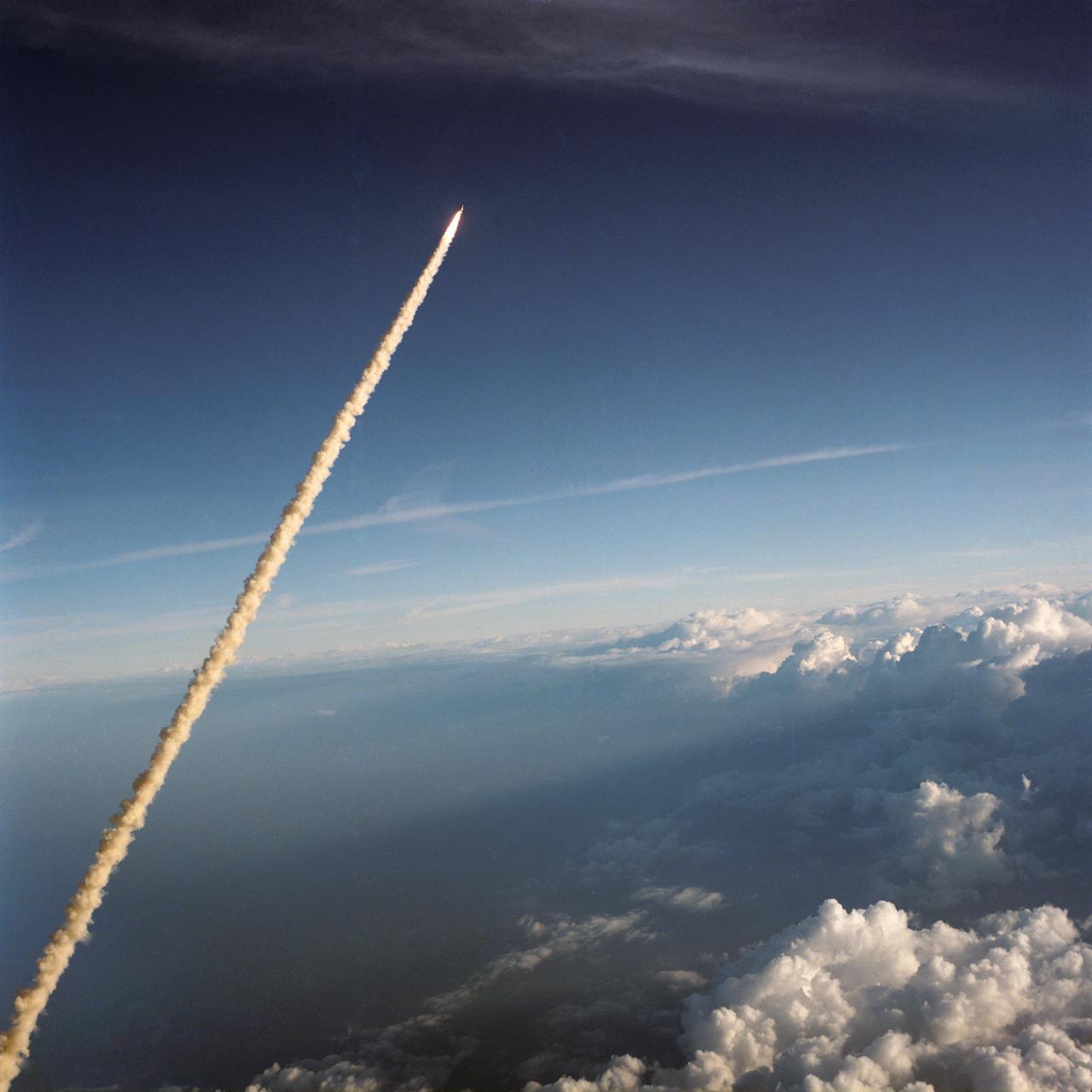 S84-26294 (3 Feb 1984) --- This scenic panorama of billowy clouds over the Atlantic and Florida and the contrasting addition of mankind's technology into the picture was provided by astronaut John W. Young and a handheld camera in the cockpit of NASA's Shuttle Training Aircraft (STA) moments after the 226 tons of spacecraft hardware were lifted off Kennedy Space Center's (KSC) Launch Pad 39A.  Inside the Space Shuttle Challenger (STS 41-B), attached here to its two Solid Rocket Boosters (SRB) and External Fuel Tank (ET), were astronauts Vance D. Brand, Robert L. Gibson, Ronald E. McNair, Bruce McCandless II and Robert L. Stewart.