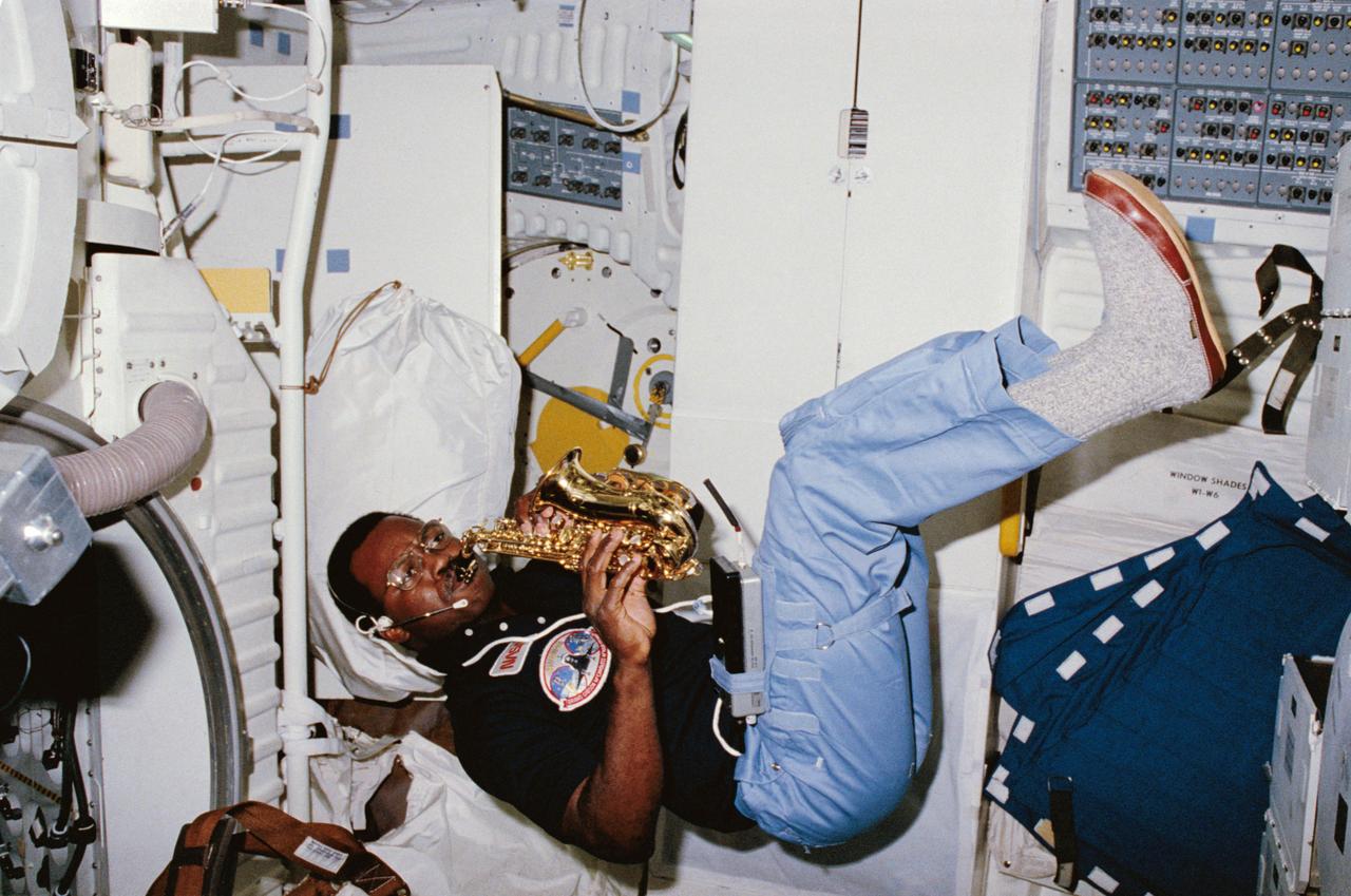 S84-27211 (8 Feb 1984) --- Astronaut Ronald E. McNair, 41-B mission specialist, uses some of his off-duty time, aboard the Space Shuttle Challenger, to play his saxaphone.