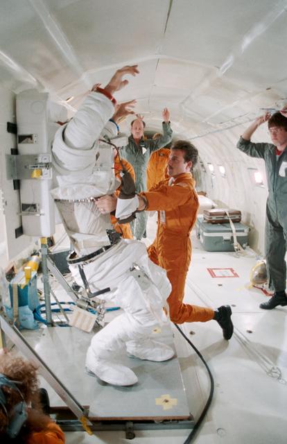 NASA image: 41-D crewmembers participate in suiting exercise in KC-135