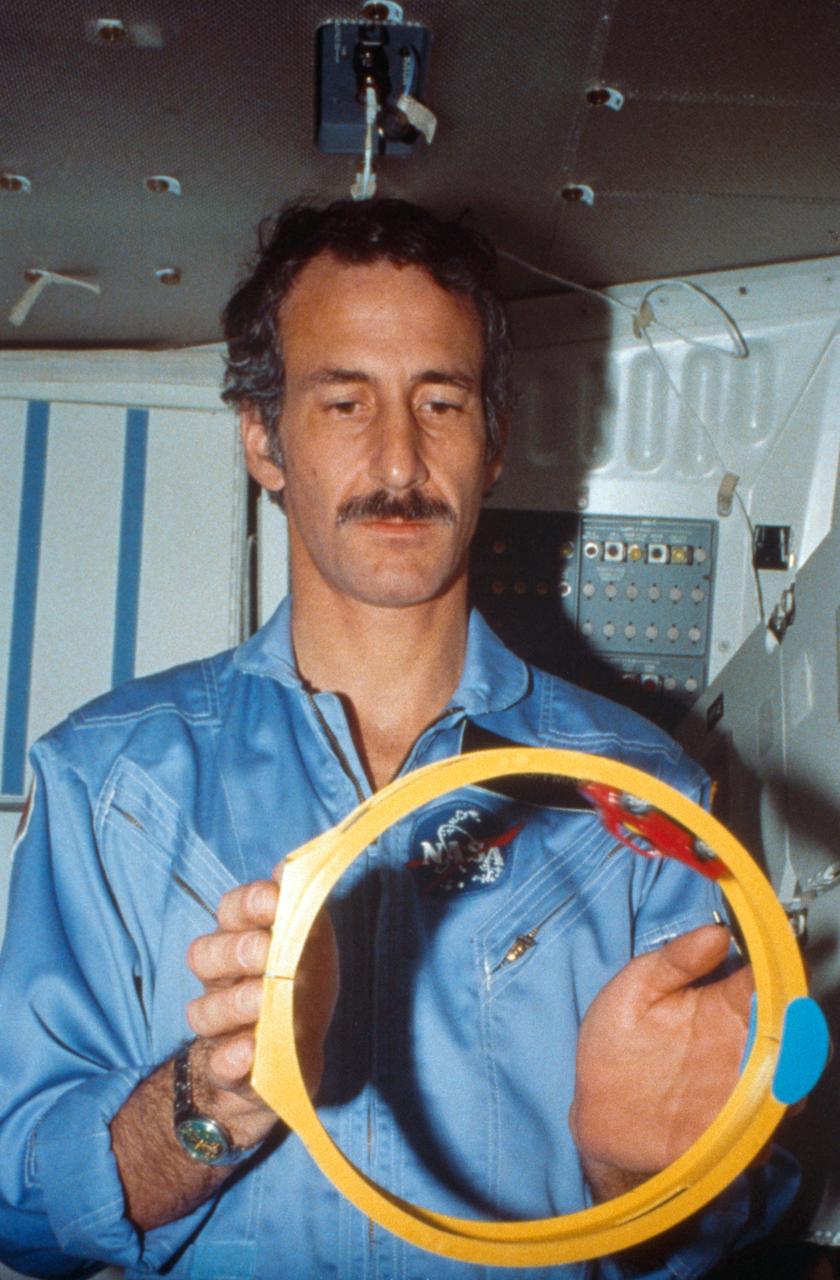 S85-26476 (1 February 1985) --- Astronaut Jeffrey A. Hoffman, 51-D mission specialist, goes through a one-G simulation of operation of a friction-powered toy car in NASA's one-G Shuttle trainer at the Johnson Space Center.