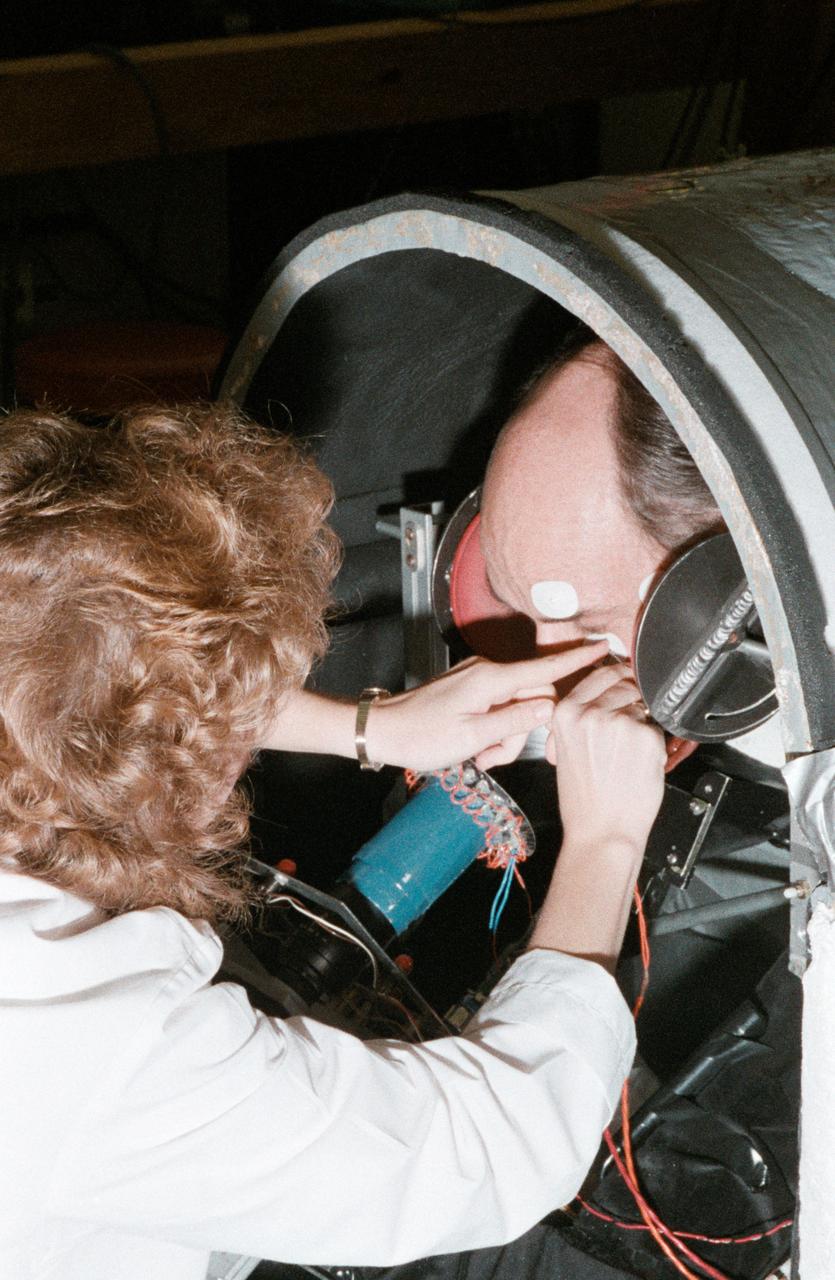 Sen. Jake Garn trains in use of equipment for medical experiments.