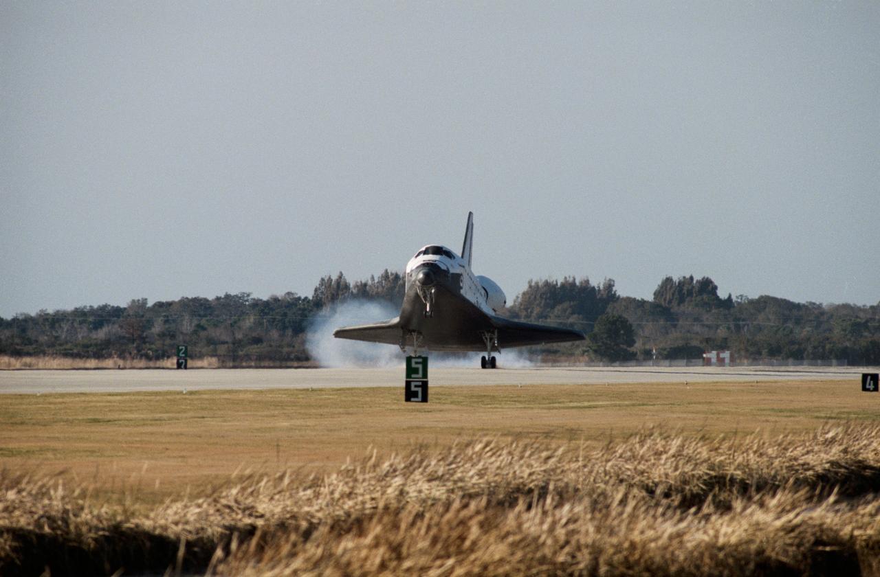S85-26933 (27 Jan 1985) --- An unusual almost-straight-on view of the Space Shuttle Discovery as its main landing gear touches down on the Shuttle landing facility runway at the Kennedy Space Center (KSC). Aboard the spacecraft for the STS-51C mission were astronauts Thomas K. (Ken) Mattingly II, Loren J. Shriver, James F. Buchli and Ellison S. Onizuka of NASA; and payload specialist Gary E. Payton of the USAF.