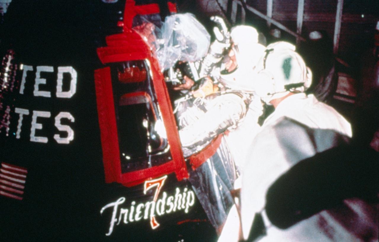S85-26952 (20 Feb. 1962) --- Project Mercury astronaut John H. Glenn Jr., enters the Friendship 7 spacecraft during the last part of the countdown on Feb. 20, 1962. At 9:47 a.m. (EST), the Atlas launch vehicle lifted the spacecraft into orbit for a three-orbit mission lasting four hours, 55 minutes and 23 seconds. Glenn and his spacecraft were recovered by the destroyer Noa just 21 minutes after landing in the Atlantic near Grand Turk Island, to successfully complete the nation's first manned orbital flight. Photo credit: NASA