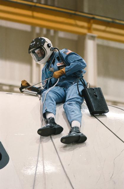 NASA image: Mission specialist Shannon W. Lucid descends from crew compartment trainer