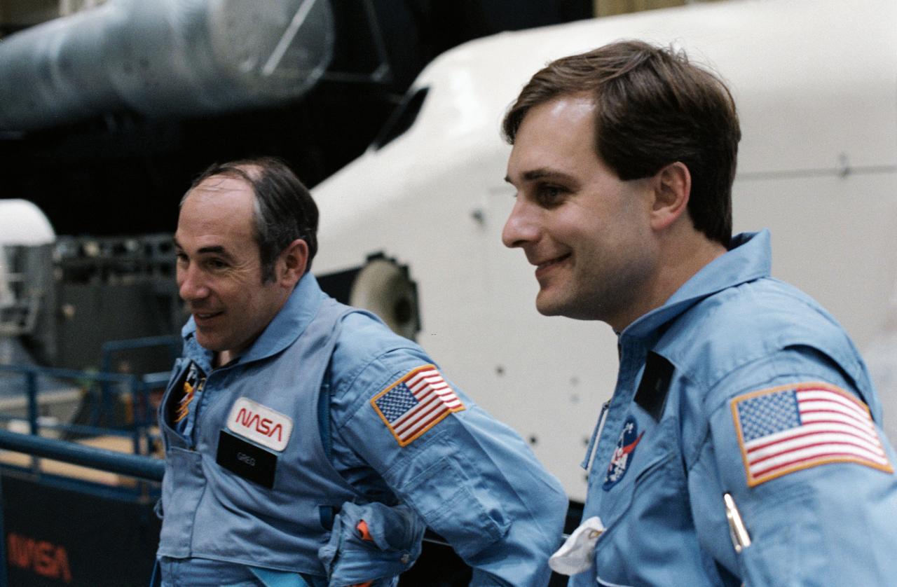 S85-28161 (1 March 1985) --- Astronauts Gregory Jarvis, left, and L. William Butterworth take a breather from training activities in Johnson Space Center’s (JSC) shuttle mock-up and integration laboratory. Jarvis and Butterworth, both Hughes Co. payload specialists, were originally assigned as payload specialists to STS-51D but were reassigned to STS-51L. Photo credit: NASA