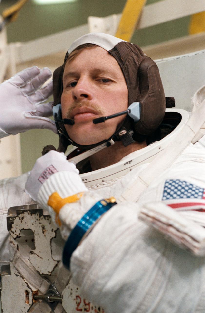 Astronaut Sherwood Springer prepares for an underwater test at Weightless Environment Training Facility (WETF) in response to the discovery of problems with the 04/13 deployed Syncom IV (LEASAT) communications satellite.   Activities, Bldg. 29, WETF for the STS-23/51D Extravehicular Activity (EVA) Simulation for Syncom IV, 04/14/1985.        1. Shuttle - Simulation (SYNCOM IV)    2. Astronaut Jerry L. Ross - Simulation (SYNCOM)   3. Astronaut Sherwood C. Spring - Simulation (SYNCOM IV)           JSC, Houston, TX