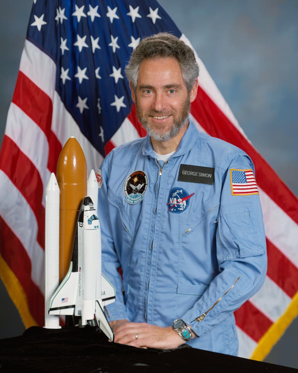 Portrait of STS 51-F Spacelab backup payload specialist George Simon, in blue flight suit