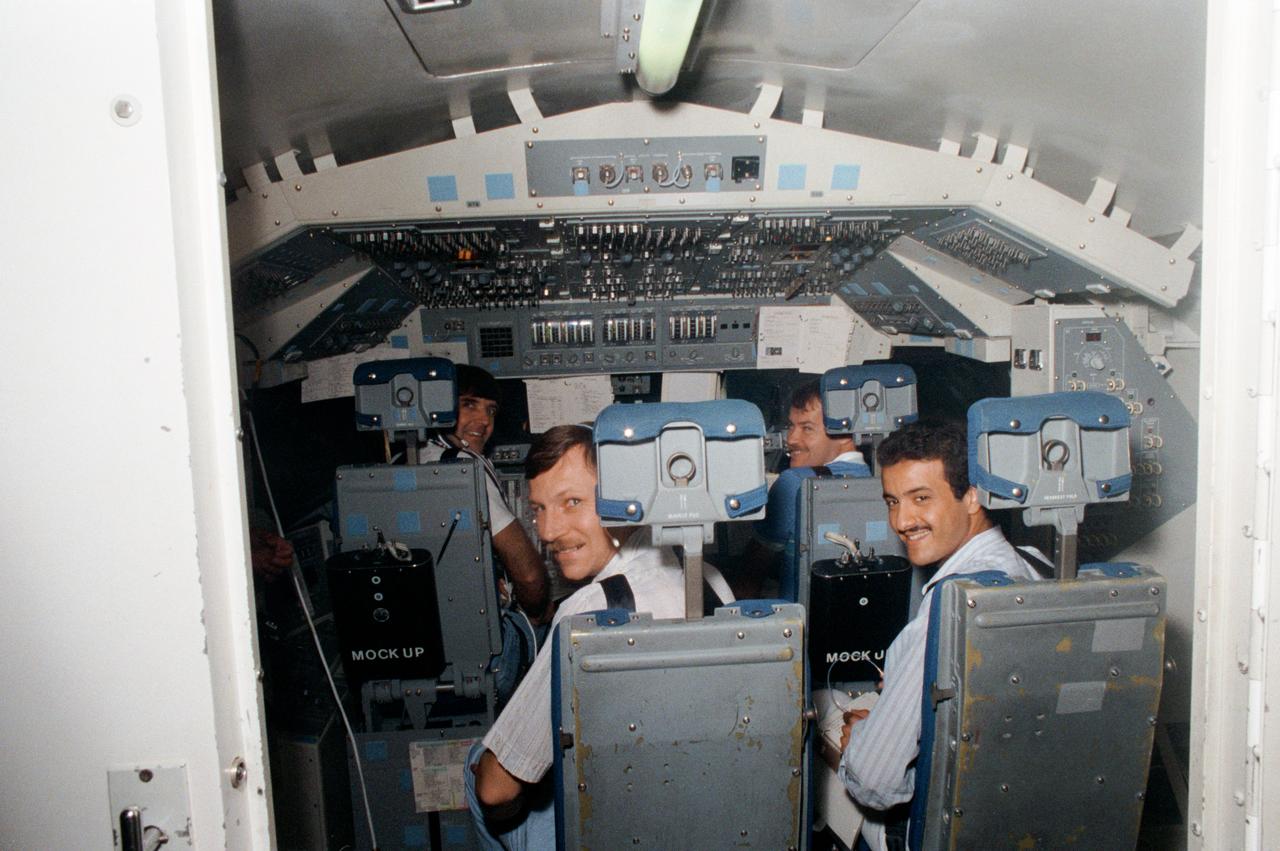 S85-31933 (17 May 1985) --- Four members of the STS 51-G crew participate in a training exercise in the shuttle mission simulation and training facility at the Johnson Space Center. Steven R. Nagel, left foreground, is a mission specialist for the flight, while Sultan Salman Abdelazize Al-Saud (right foreground) is a payload specialist. In the background are astronauts Daniel C. Brandenstein (left) in the commander's station and John O. Creighton in the pilot's position. Photo credit: NASA/ Otis Imboden of National Geographic