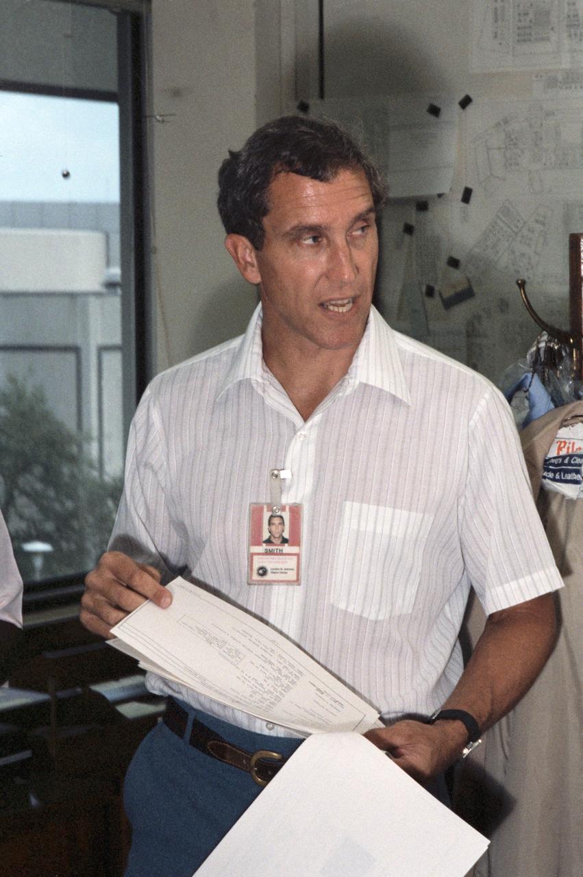 S85-40174 (5 Sept. 1985) --- In Johnson Space Center’s (JSC) Astronaut Office, astronaut Michael J. Smith, STS-51L pilot, looks over part of the flight plan for his upcoming space mission.    EDITOR’S NOTE: The STS-51L crew members lost their lives in the space shuttle Challenger accident moments after launch on January 28, 1986 from the Kennedy Space Center (KSC). Photo credit: NASA