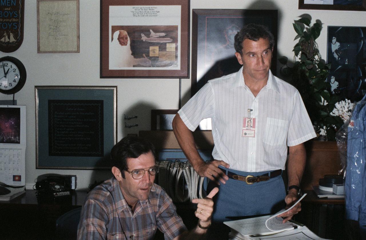 Candid views of the STS-33/51L Crew during study periods in their offices on 09/09/1985. Astronauts Michael J. Smith (right), STS 51L Pilot, and Francis R. (Dick) Scobee, 51L Mission Commander, are photographed in conversation while in training. JSC, HOUSTON, TX