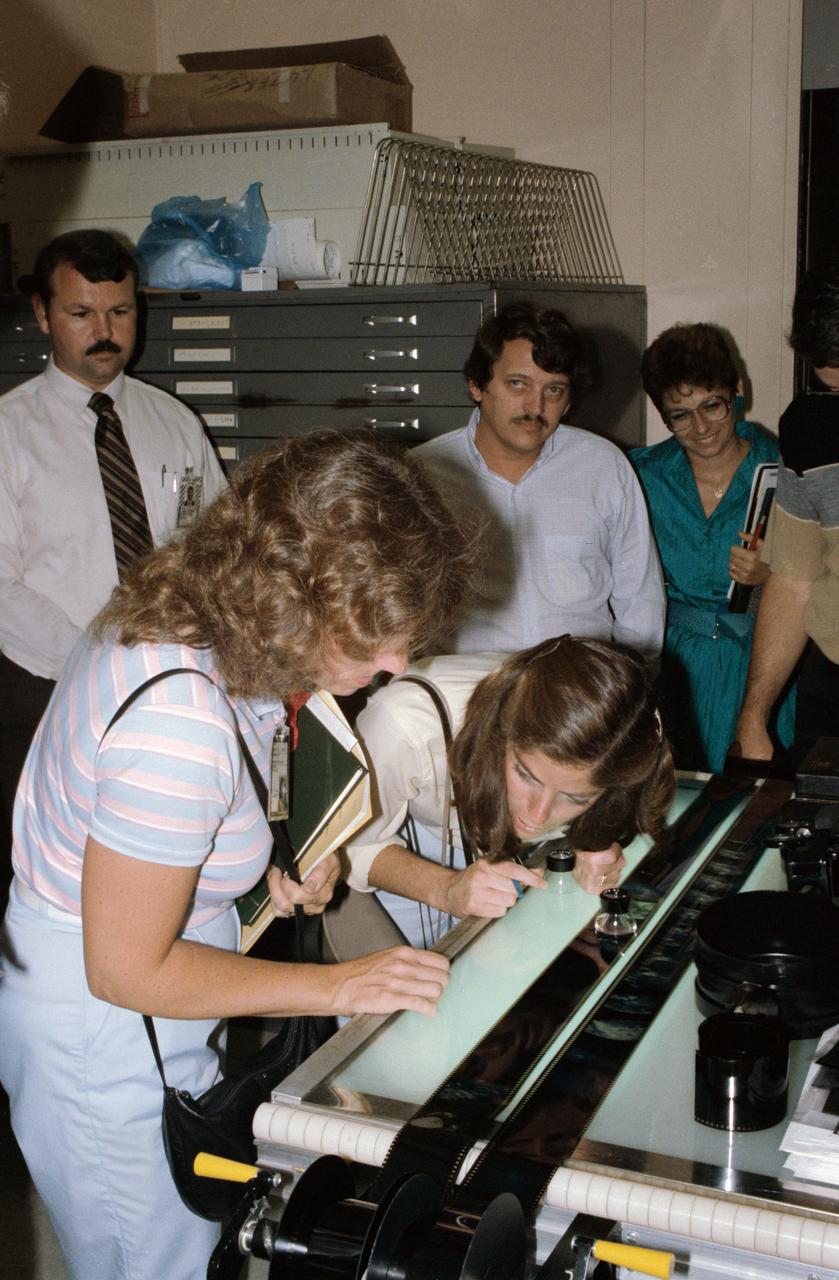 View of STS-33/51L Prime Teacher, Christa McAuliffe (left foreground) and Barbara Morgan (second left), both "Teacher in Space" Trainees, review film shot while training with Arriflex camera.       1. McAuliffe, S. Christa - Photography  2. Morgan, Barbara - Photography