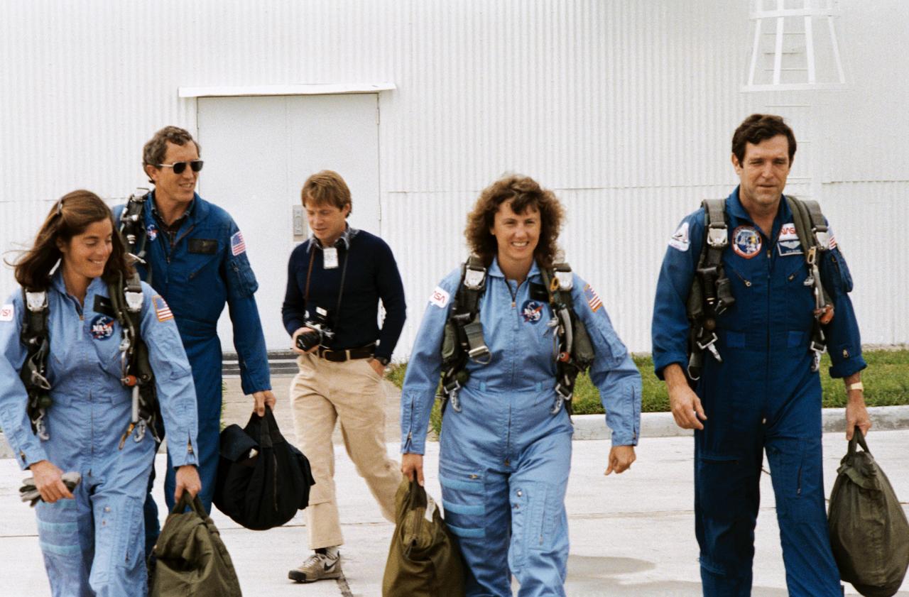 S85-41443 (12 Dec. 1985) --- Assigned STS-51L mission crew members, and a backup, are pictured at Ellington Air Field following brief flights in NASA's T-38 jet trainers.  Left to right are Barbara R. Morgan, Michael J. Smith, an unidentified visitor, S. Christa McAuliffe and Francis R. (Dick) Scobee.  Morgan is serving as backup, to McAuliffe's payload specialist position, as Teacher-in-Space Project representative on the flight.  Scobee and Smith are commander and pilot, respectively, for NASA's 25th STS flight. Photo credit: NASA