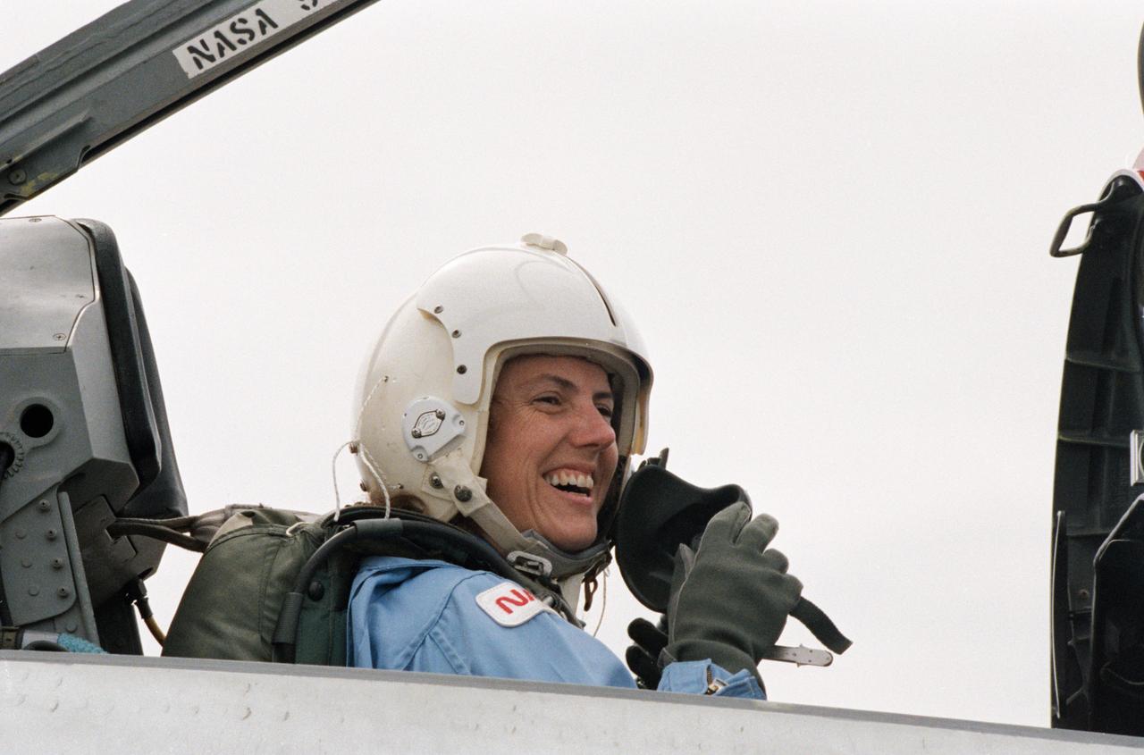 Sharon Christa McAuliffe, the Teacher in Space participant from Concord, New Hampshire, prepares for a ride in the rear station of one of NASA's T-38 jet trainers at Ellington Field near JSC.