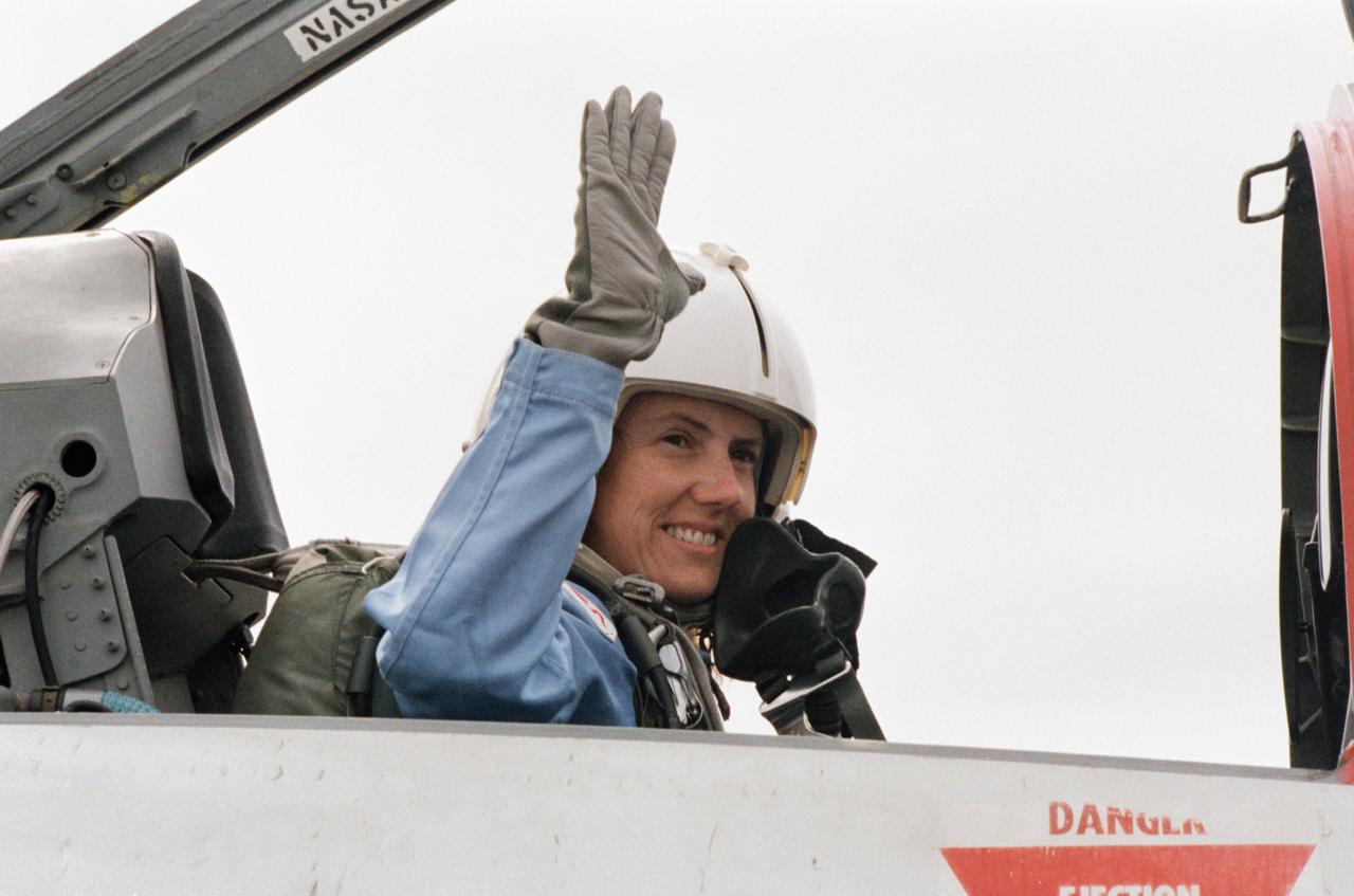 Sharon Christa McAuliffe, the Teacher in Space participant from Concord, New Hampshire, prepares for a ride in the rear station of one of NASA's T-38 jet trainers at Ellington Field near JSC.
