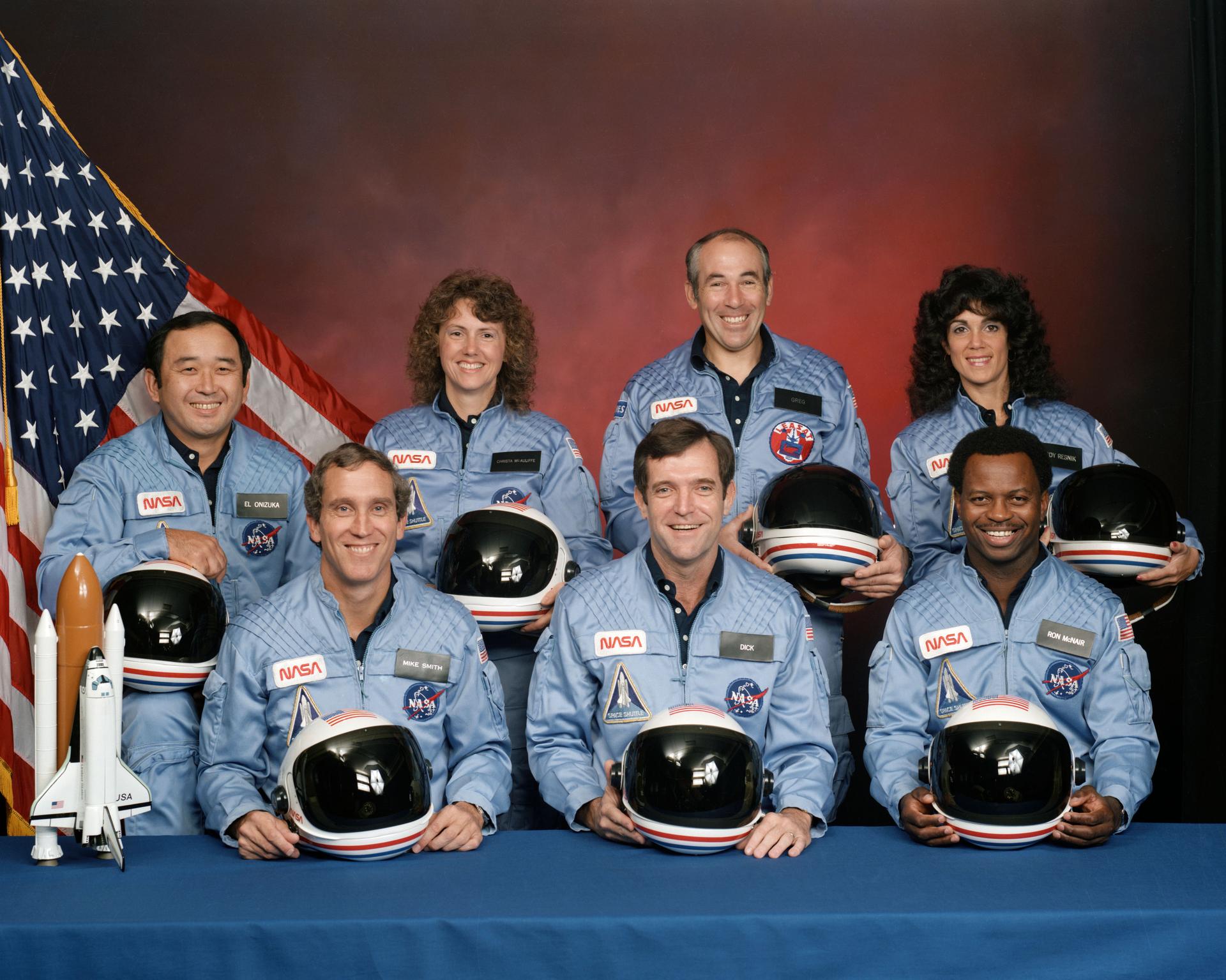 S85-44253 (November 1985) --- Five astronauts and two payload specialists make up the crew, scheduled to fly aboard the space shuttle Challenger in January of 1986. Crew members are (left to right, front row) astronauts Michael J. Smith, Francis R. (Dick) Scobee and Ronald E. McNair; Ellison S. Onizuka, Sharon Christa McAuliffe, Gregory Jarvis and Judith A. Resnik. McAuliffe and Jarvis are payload specialists, representing the Teacher in Space Project and Hughes Company, respectively. Photo credit: NASA    (NOTE: On Jan. 28, 1986, the seven Challenger crew members lost their lives following an explosion during the launch phase of the STS-51L mission.)