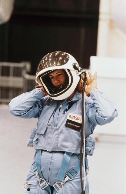 Christa McAuliffe removing helmet after egress training