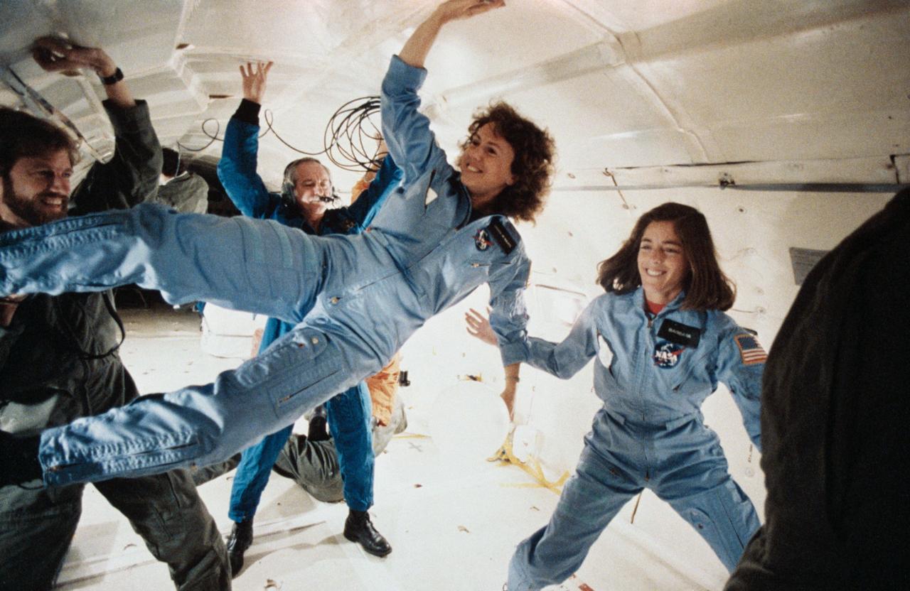 S86-25191 (for release January 1986) --- The two representatives of the Teacher-in-Space Project continue their training program at the Johnson Space Center with an additional flight aboard NASA?s KC-135 ?zero gravity? aircraft. Sharon Christa McAuliffe, left, is prime crew payload specialist, and Barbara R. Morgan is in training as backup payload specialist. The photo was taken by Keith Meyers of New York Times. Photo credit: NASA