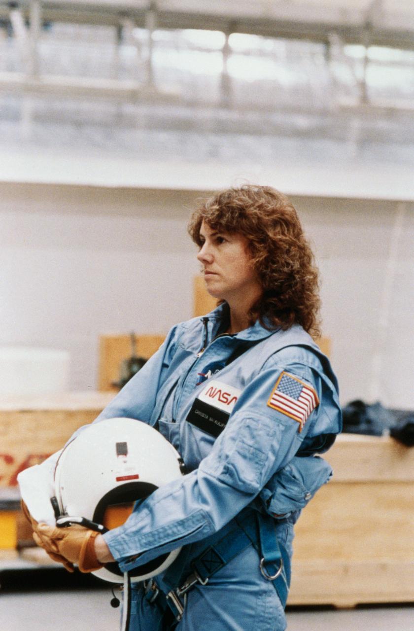 S86-25251 (January 1986) --- Sharon Christa McAuliffe, payload specialist for STS-51L, takes a breather following a busy day?s training in the Johnson Space Center?s Shuttle Mock-up and Integration Laboratory.  McAuliffe, a New Hampshire school teacher, was chosen from among ten finalists in the Teacher-in-Space Project to serve as citizen observer aboard the Challenger. This photo was taken by Keith Meyers of the New York Times. Photo credit: NASA