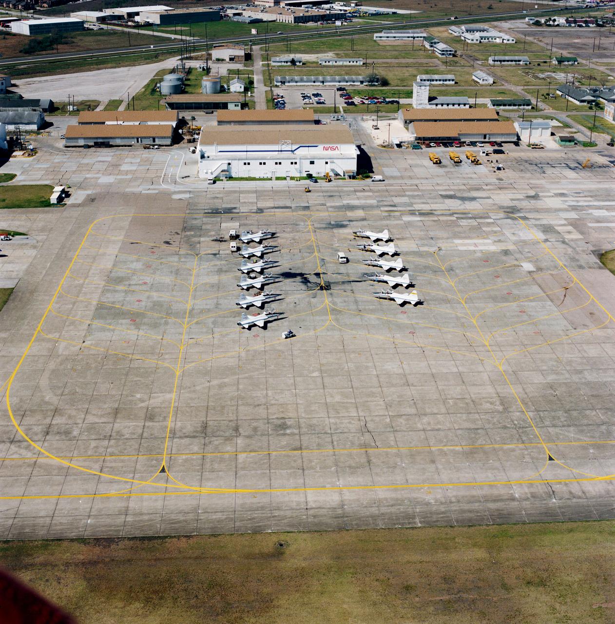Aerial view of the NASA hangar and a line-up of the NASA T-38 trainer aircraft used by the astronauts at Ellington Field.