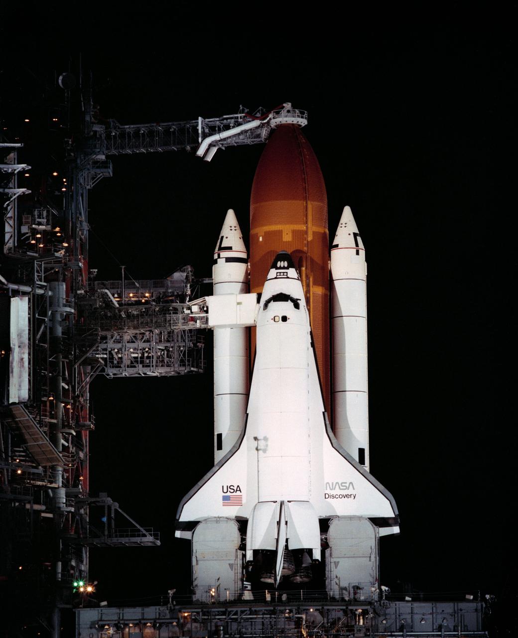 The Space Shuttle Discovery moves towards Pad "A" on the crawler transporter       for its maiden flight. The Shuttle Discovery is poised atop Pad "A" at Complex 39 prior ot the STS-41D mission.     KSC, FL