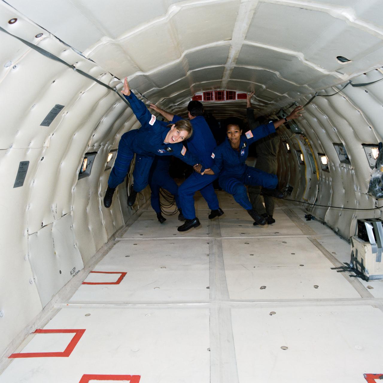 S87-44950 --- Group 12, 1987 Astronaut Class, candidates (ASCANs) N. Jan Davis (left) and Mae C. Jemison freefloat during the seconds of microgravity created aboard the KC-135 NASA 930 aircraft's parabolic flight. Davis and Jemison, two of the recently-named ASCANs, were taking a familiarization flight aboard the KC-135 "zero gravity" aircraft. Photo credit: NASA