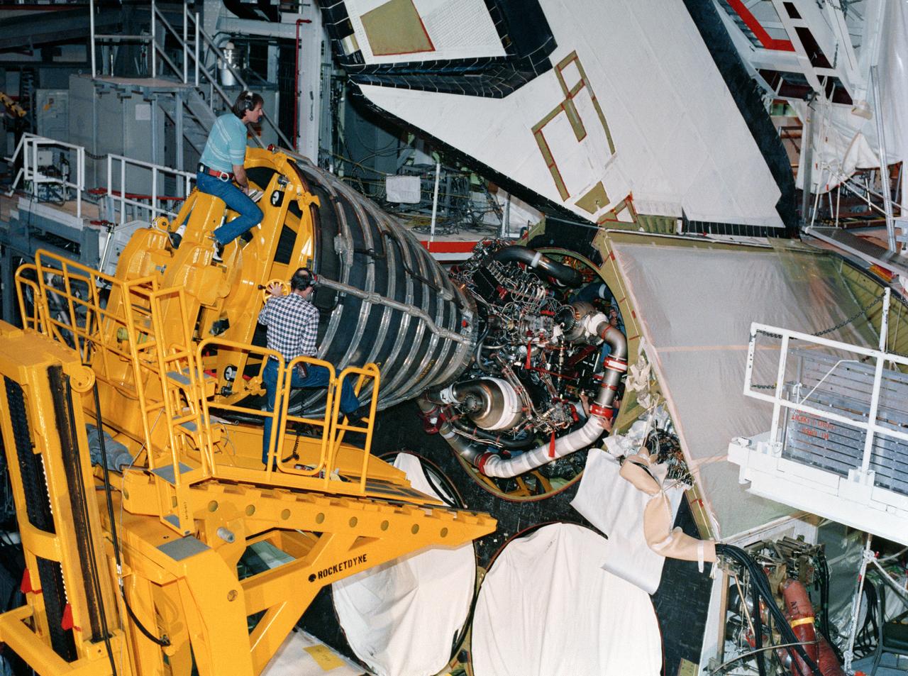 S88-29076 (10 Jan 1988) --- KSC employees work together to carefully guide a 7,000 pound main engine into the number one position in Discovery's aft compartment.  Because of the engine's weight and size, special handling equipment is needed to perform the installation.  Discovery is currently being prepared for the upcoming STS-26 mission in bay 1 of the Orbiter Processing Facility.  This engine, 2019, arrived at KSC on Jan. 6 and was installed Jan. 10.  The other two engines are scheduled to be installed later this month.  The shuttle's three main liquid fueled engines provide the main propulsion for the orbiter vehicle.  The cluster of three engines operate in parallel with the solid rocket boosters during the initial ascent.