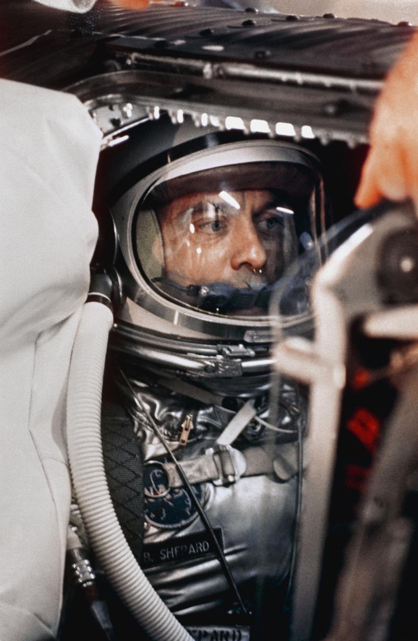 S88-31374 (29 April 1961) --- A close-up of astronaut Alan B. Shepard Jr. in his space suit with his helmet on inside the Mercury capsule. He is undergoing a flight simulation test with the capsule mated to the Redstone booster. This will be the first attempt to put a man into space by the U.S. aboard a Mercury spacecraft, launched atop a Redstone rocket.  The suborbital trajectory will be down the Atlantic Missile Range. Photo credit: NASA or National Aeronautics and Space Administration