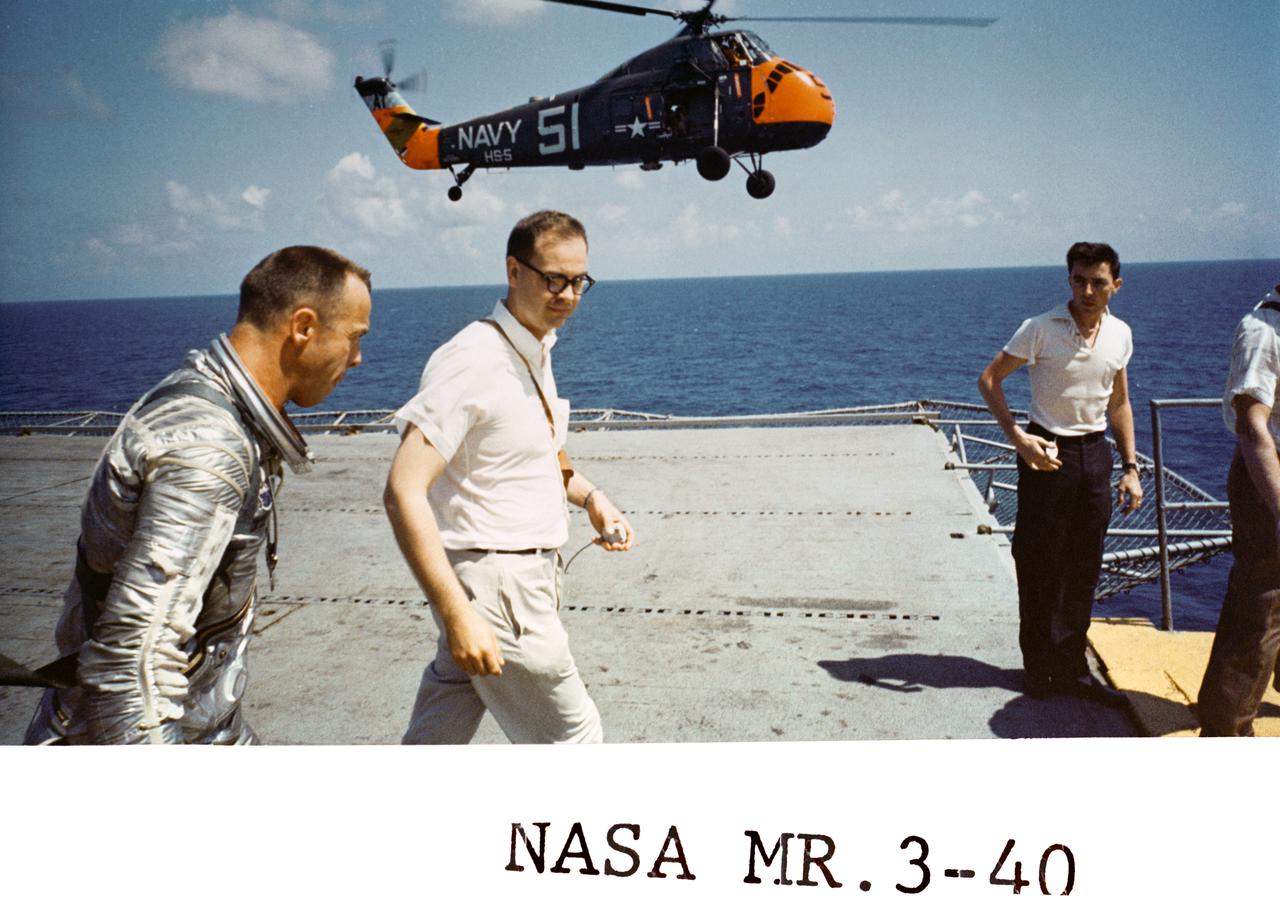 S88-31380 (5 May 1961) --- Astronaut Alan B. Shepard Jr., strides across the deck of the U.S. Navy Carrier Champlain following an inspection of his Freedom 7 capsule.  Shepard had just completed the first manned U.S. space mission, a 15-minute suborbital flight. (NASA Hq. Photo No., MR3-40) Photo credit: NASA or National Aeronautics and Space Administration
