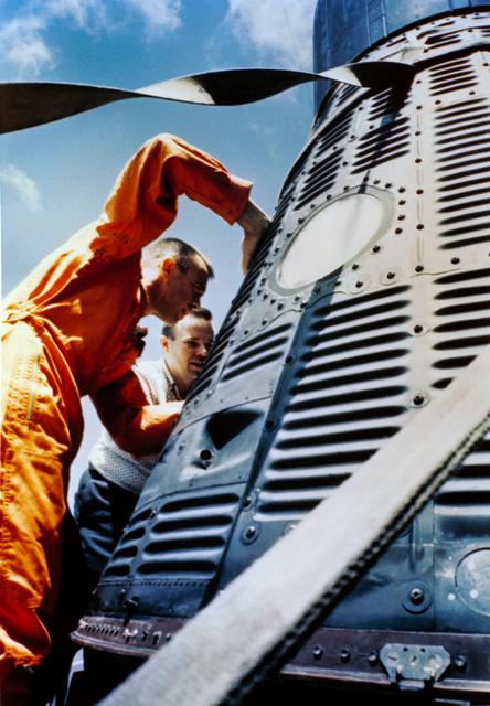NASA image: Astronaut Alan Shepard inspects his capsule on U.S. Champlain after recovery