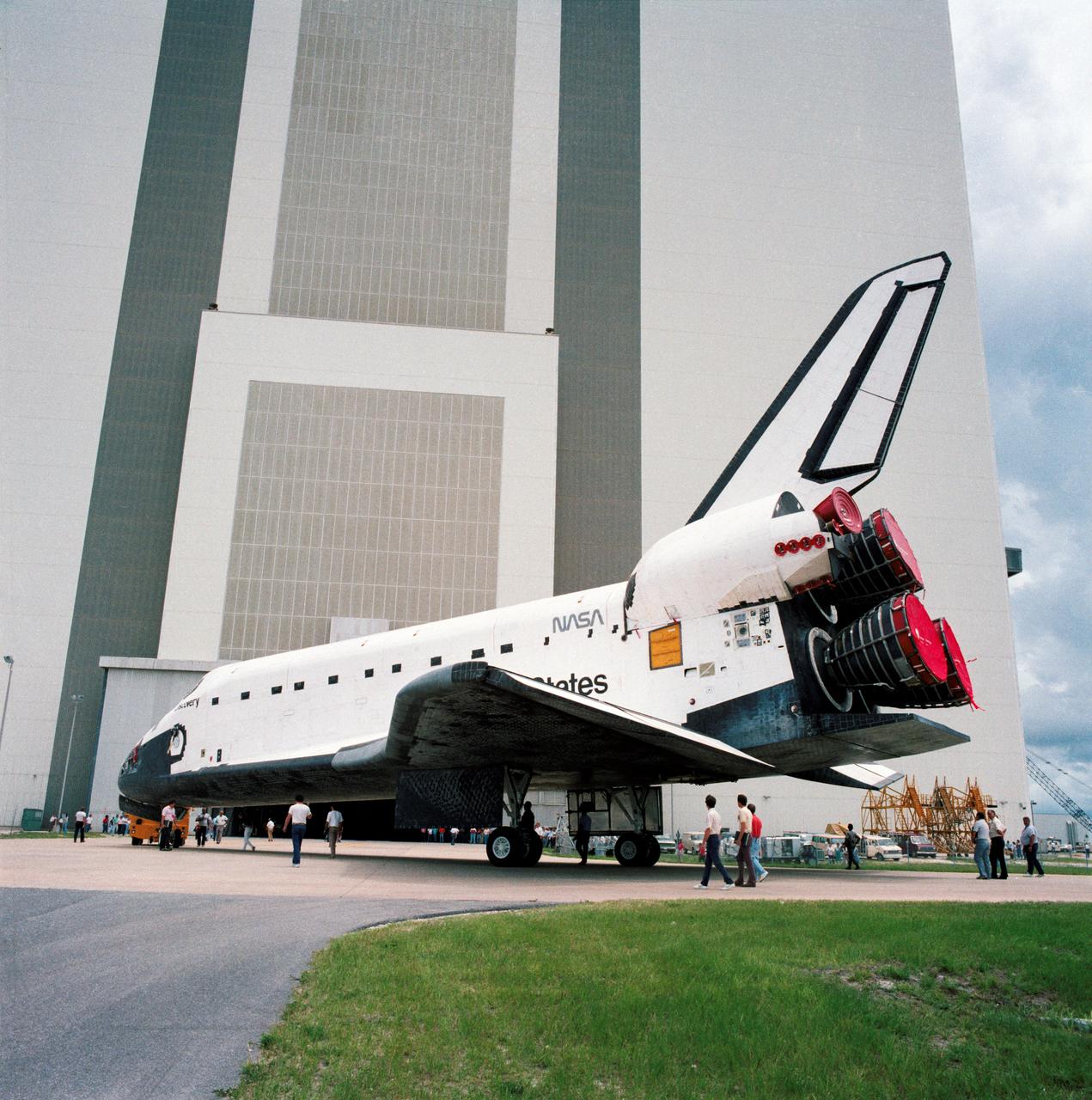 S88-42092 (15 July 1988) --- STS-26 Discovery, Orbiter Vehicle (OV) 103, rollover at Kennedy Space Center (KSC) is closely monitored by engineers and technicians in the late stages of the move from the orbiter processing facility (OPF) to the vehicle assembly building (VAB) as preflight preparations continue. A large crowd of KSC employees and other spectators watches in the background as OV-103, supported by its landing gear, is pulled toward VAB (background). While in the VAB, OV-103 will be mated to two solid rocket boosters (SRBs) and an external fuel tank.