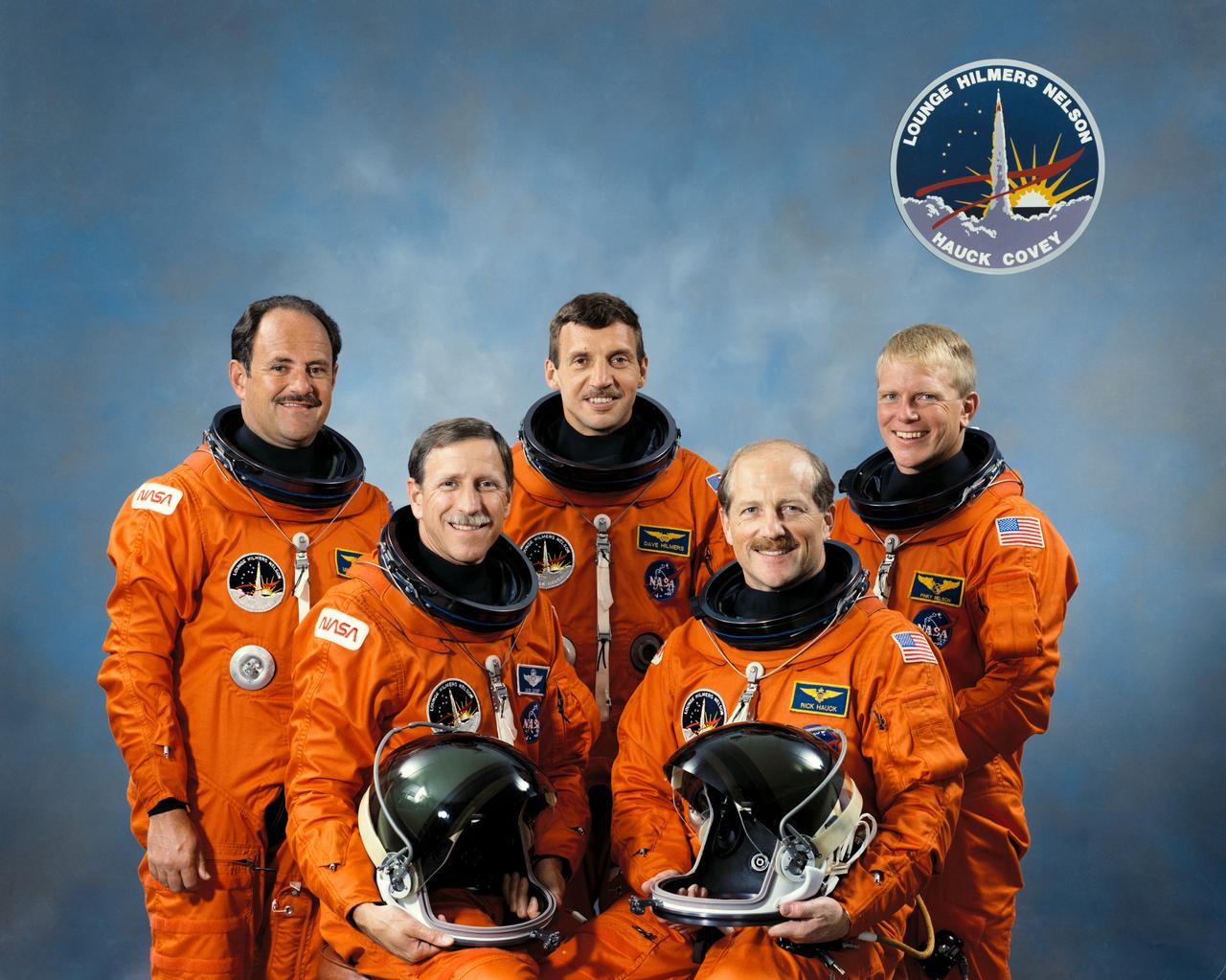 S88-47522 (10 Sept 1988) --- These five veteran astronauts have been training for over a year to serve as NASA's crew aboard the Space Shuttle Discovery for STS-26. On the front row are Astronauts Frederick H. (Rick) Hauck (right), commander; and Richard O. Covey, pilot. On the back row are Astronauts John M. (Mike) Lounge, David C. Hilmers and George D. Nelson -- all mission specialists. The crewmembers are wearing the orange partial pressure garments that they will be wearing on the launch and entry phases of the flight, scheduled for launch later this month.