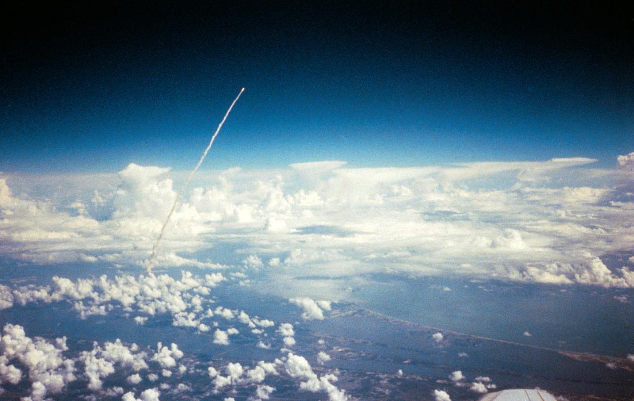 Long range view of an unidentified space shuttle lift off taken from an unidentified high flying aircraft.