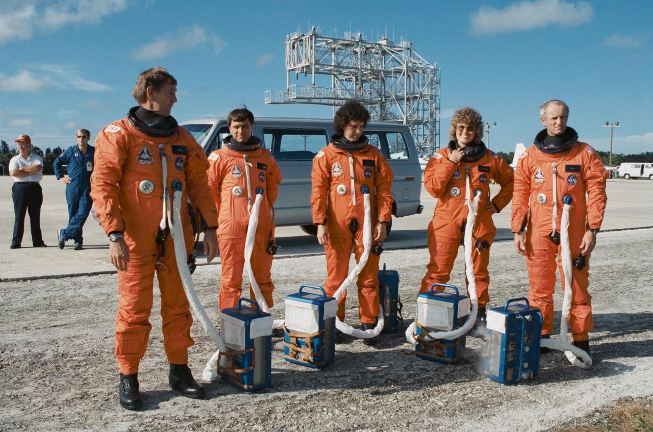 S89-45249 (13 Sept 1989) --- The astronaut crewmembers for NASA's STS-34 mission prepare to participate in emergency egress training in their partially pressurized flight suits with attached cooling packs at the Shuttle landing facility.  Left to right are Astronauts Michael J. McCulley, pilot; Franklin R. Chang-Diaz, Ellen S. Baker and Shannon W. Lucid, all mission specialists; and Donald E. Williams, mission commander.  The five were at the Kennedy Space Center (KSC) primarily to participate in the Terminal Countdown Demonstration Test (TCDT). The Space Shuttle Atlantis is scheduled to be launched October 12.  Primary payload for the five-day mission is the spacecraft Galileo which will be deployed in space begin its journey to Jupiter.