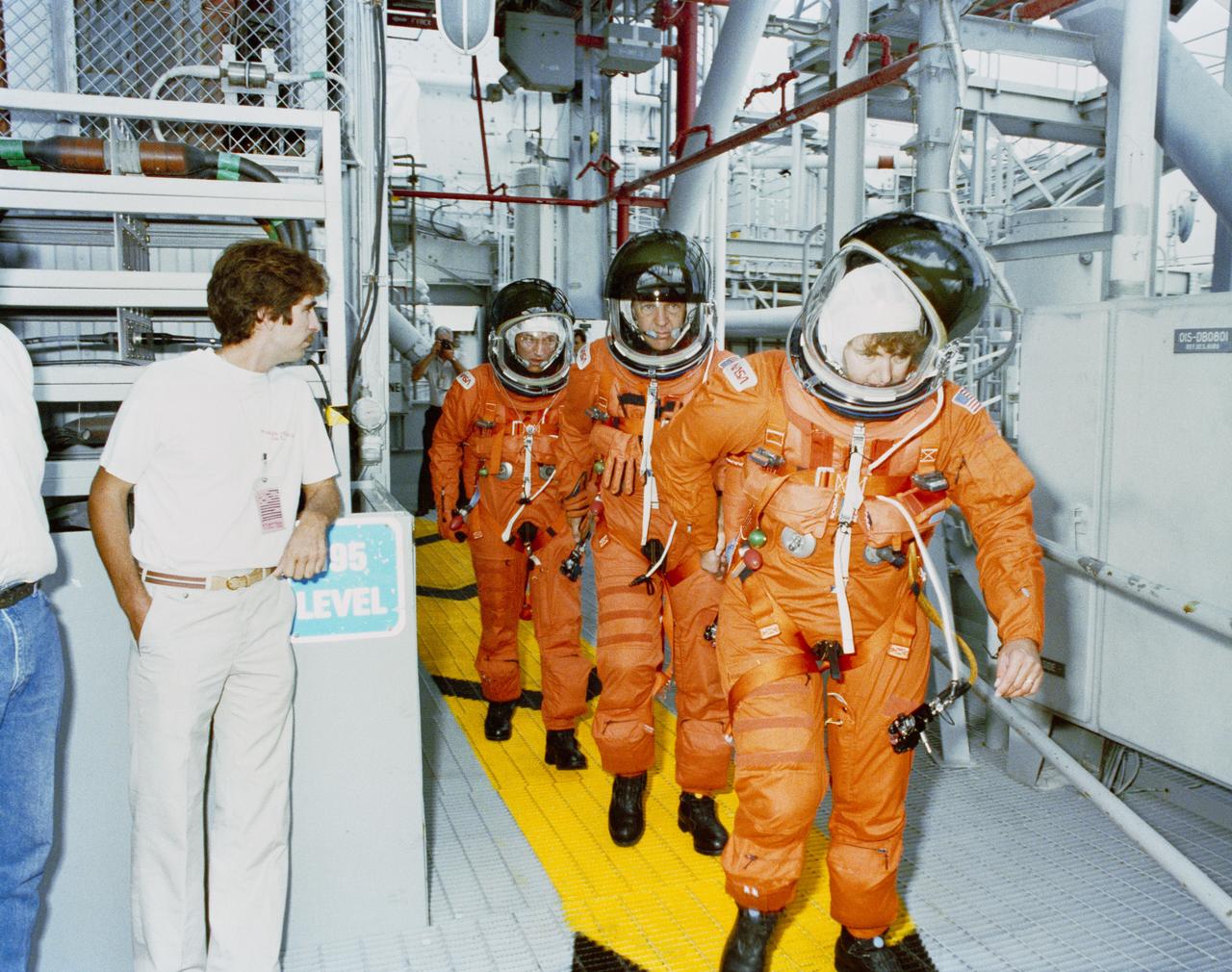 S89-46513 (15 Sept 1989) --- Three members of the STS-34 crew rehearse  for their pre-launch procedures at Launch Pad 39B during Terminal Countdown Demonstration Test (TCDT) activities at Kennedy Space Center (KSC).  From the foreground, Astronauts Shannon W. Lucid, Michael J. McCulley and Donald E. Williams are at the 195-ft. level of at Pad B.   The crew entered Atlantis for the mock countdown. The five astronauts are expected to spend more than five days in Earth orbit next month, with their primary objective being to release the Galileo spacecraft and send it on its way to Jupiter.  Not in the frame are Astronauts Franklin R. Chang-Diaz and Ellen S. Baker. (KSC-89PC-898)
