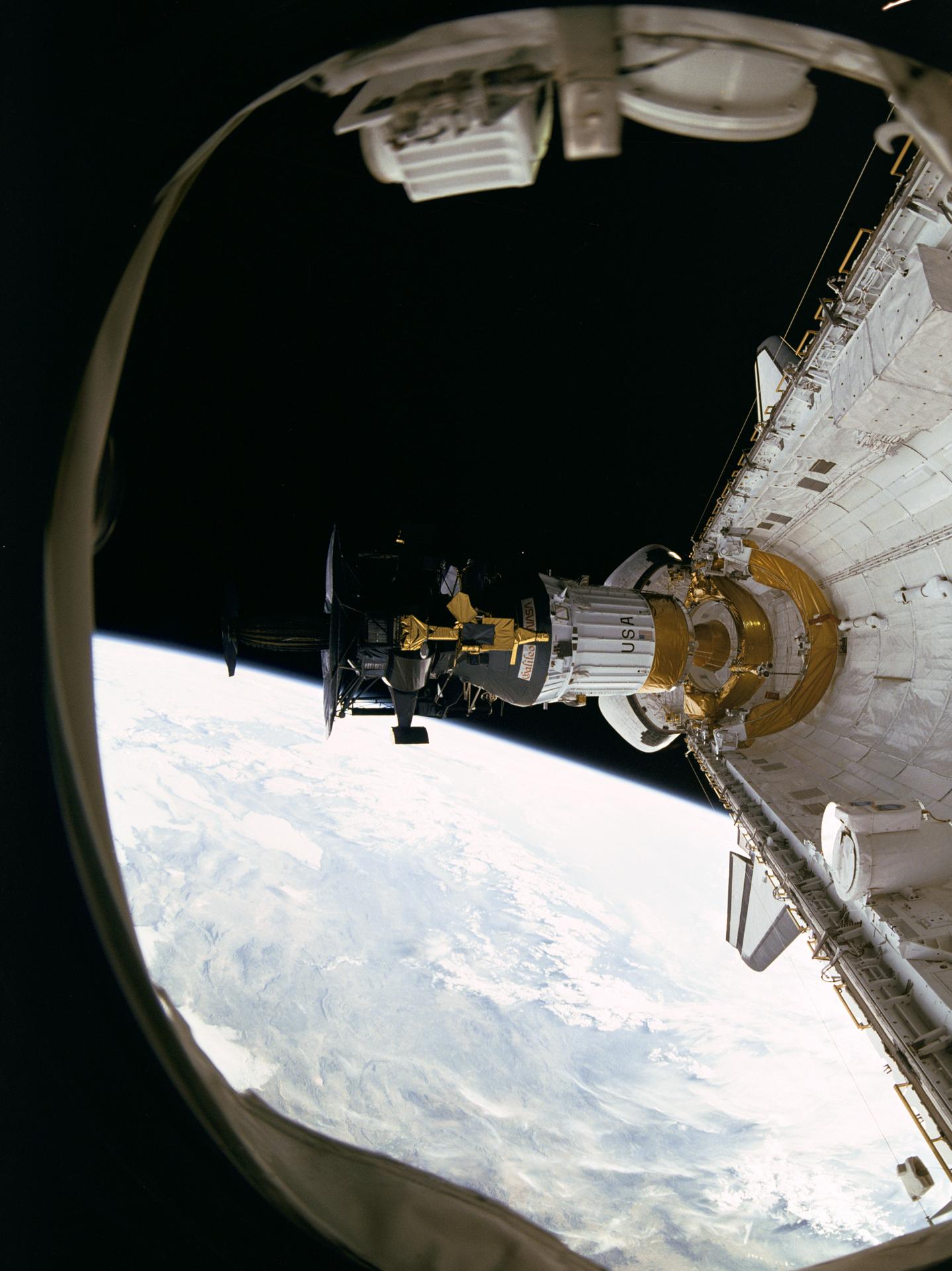 Photo taken from the STS-34 shuttle window of the Galileo spacecraft being deployed. The Earth is seen in the background.