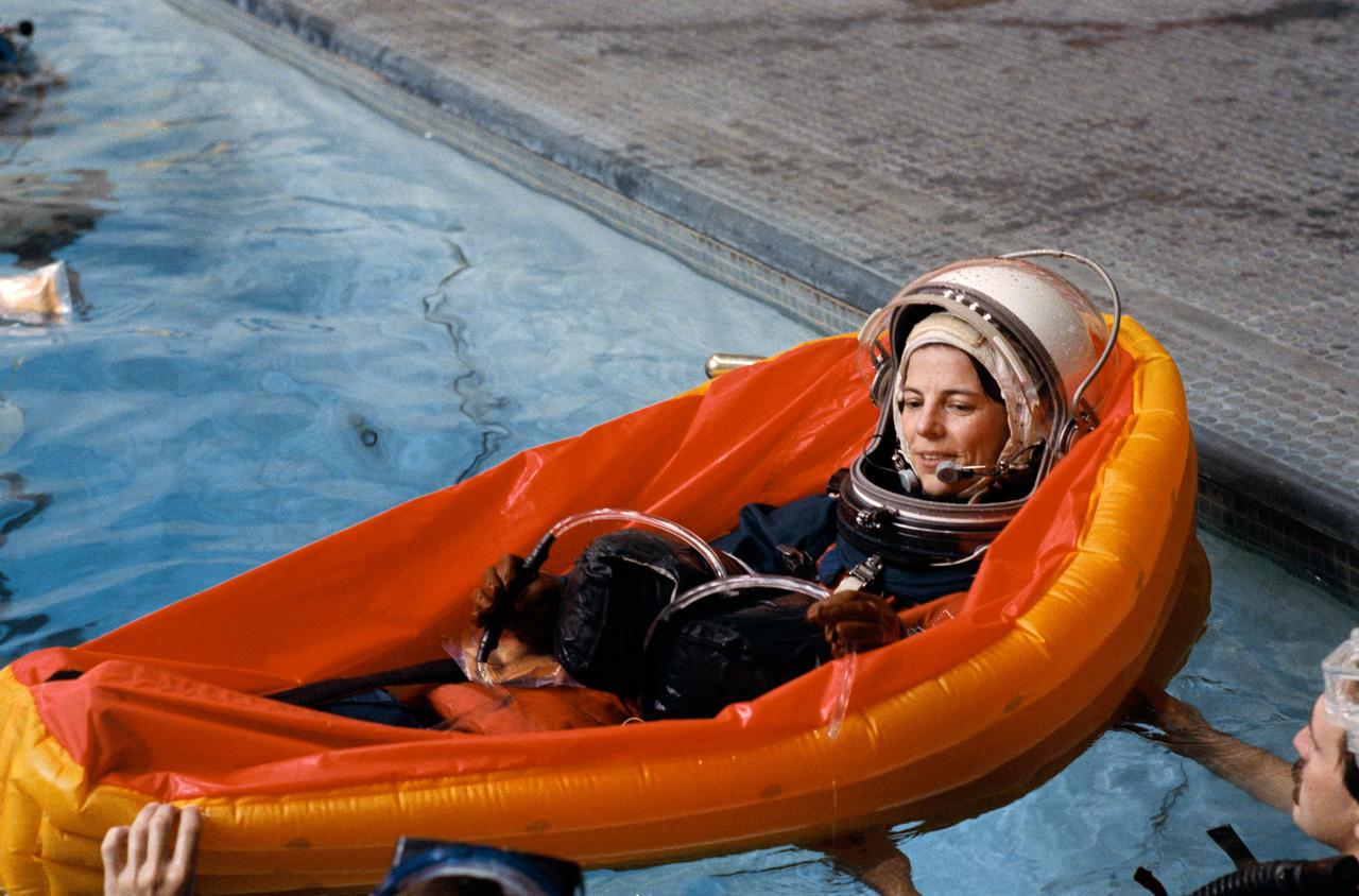 STS-32 Mission Specialist (MS) Bonnie J. Dunbar, wearing a launch and entry suit (LES) and lauch and entry helmet (LEH), in a single-occupant (one man) lift raft enlists the aid of two SCUBA-equipped divers as she floats in 25 ft deep pool located in JSC's Weightless Environment Training Facility (WETF) Bldg 29. During the exercises the crew practiced the procedures to follow in the event of an emergency aboard the Space Shuttle and familiarized themselves with post-Challenger pole system of emergency egress.
