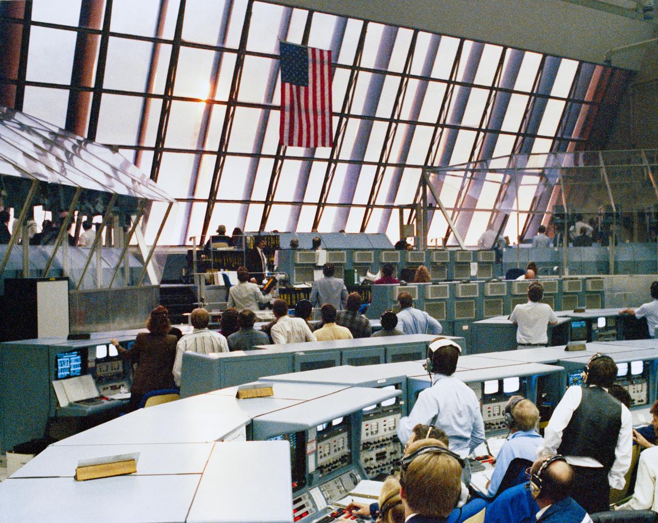S90-29047 99Jan 1990) --- At the conclusion of another successful countdown, members of the KSC launch team in Firing Room 1 rivet their eyes on the skies to the east of the Launch Control Center. Their reward was a glimpse of Columbia burning its way upward up from Complex 39's Pad A. The brilliant flame of the boosters hurled shadows and patches of light into the firing room's interior.  Launch of the STS-32 mission at 7:35 a.m. EST today marked the beginning of a busy year which could see the launch of as many as 10 missions.