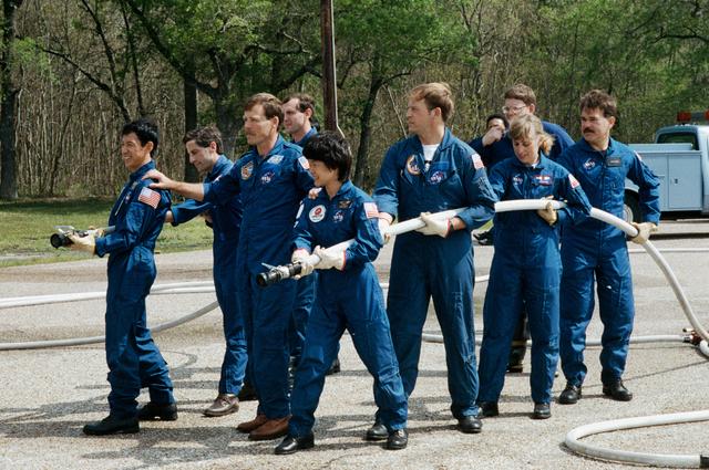 NASA image: STS-47 crewmembers and backups during JSC fire fighting exercises