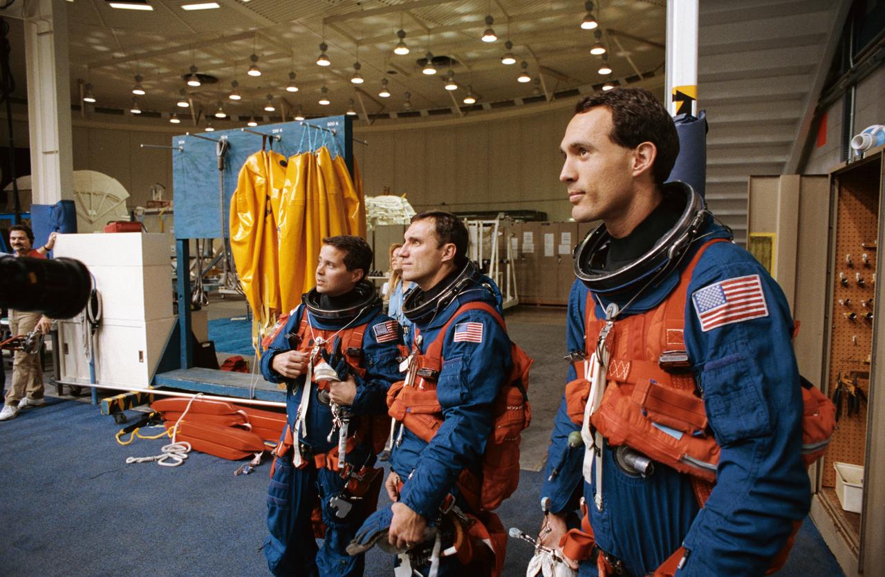 S93-31929 (24 March 1993) --- The three mission specialists for NASA's STS-51 mission watch as a crewmate (out of frame) simulates a parachute jump into water during emergency bailout training exercises at the Johnson Space Center's Weightless Environment Training Facility (WET-F).  Left to right are astronauts Daniel W. Bursch, Carl E. Walz and James H. Newman.  Out of frame are astronauts Frank L. Culbertson and William F. Readdy, commander and pilot, respectively.
