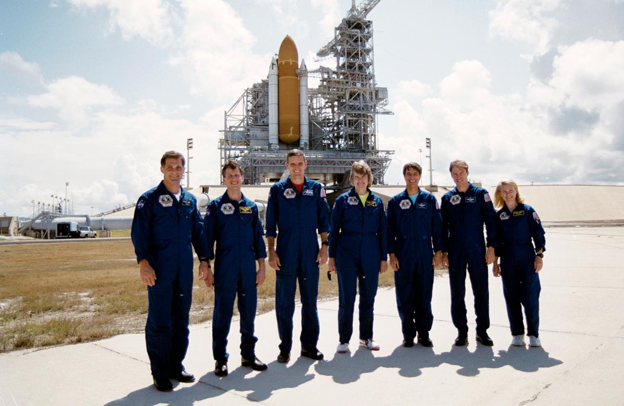 S93-45003 (20 Sept 1993) --- Posing for a crew portrait, in front of the Space Shuttle Columbia at Launch Pad 39B, are the seven STS-58 astronauts.  They are, left to right, David A. Wolf, mission specialist; Martin J. Fettman, payload specialist; William S. McArthur and Shannon W. Lucid, mission specialists; John E. Blaha, mission commander; Richard A. Searfoss, pilot; and Rhea Seddon, payload commander.  The crew was in Florida for the Terminal Countdown Demonstration Test (CDDT) in preparation for next month's launch aboard Columbia. (Kennedy Space Center Photo ID: KSC-93-PC-1253)