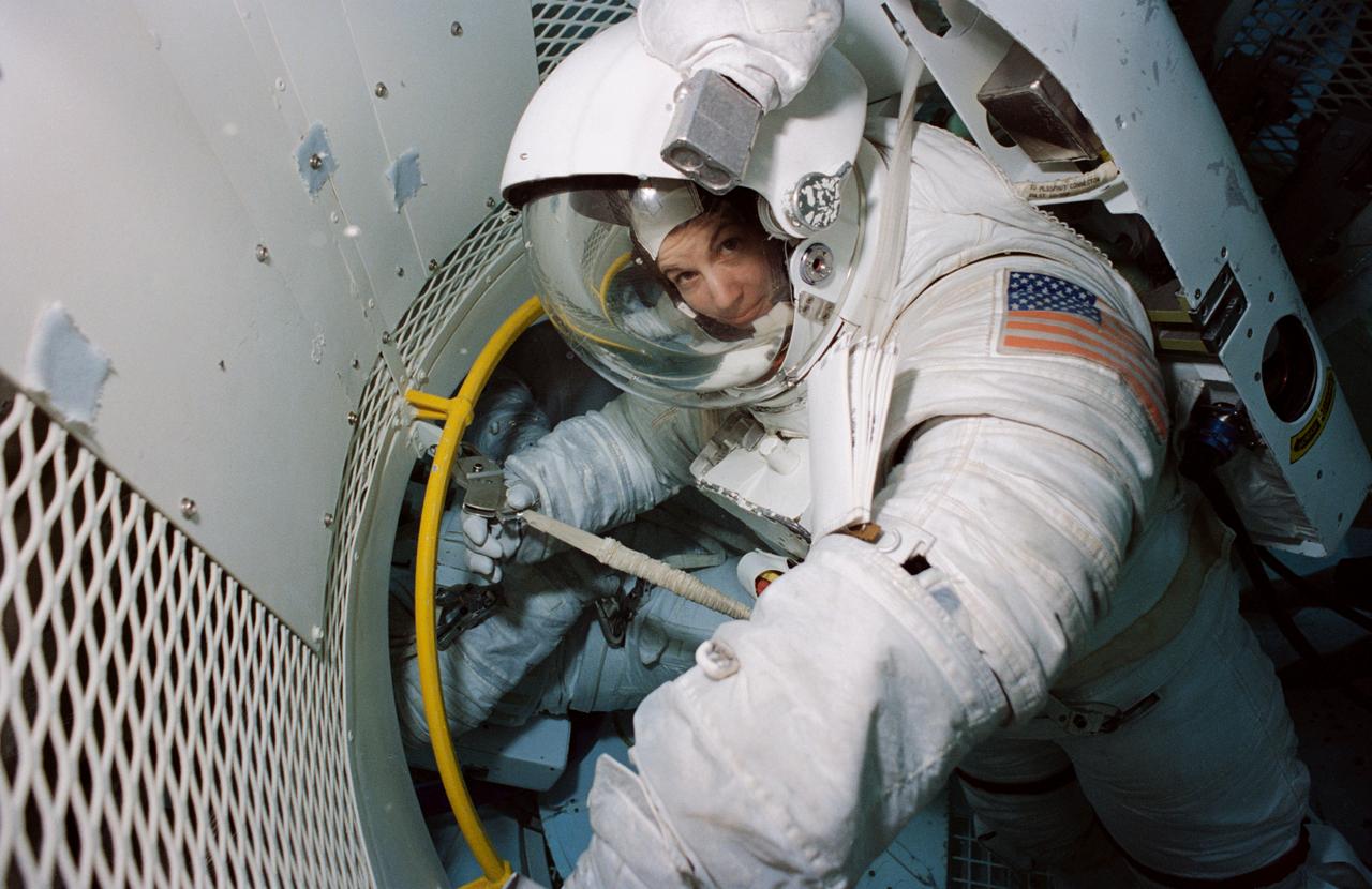 S94-25956 (April 1994) --- Astronaut Catherine G. Coleman, mission specialist, wearing a high-fidelity training version of an Extravehicular Mobility Unit (EMU), trains for a contingency space walk at the Johnson Space Center?s (JSC) Weightless Environment Training Facility (WET-F). Coleman has recently been named as one of seven crew members for the U.S. Microgravity Laboratory (USML-2) mission. The 25-feet deep pool is used to train astronauts for mission specific space walk chores as well as for contingency Extravehicular Activity (EVA) tasks.
