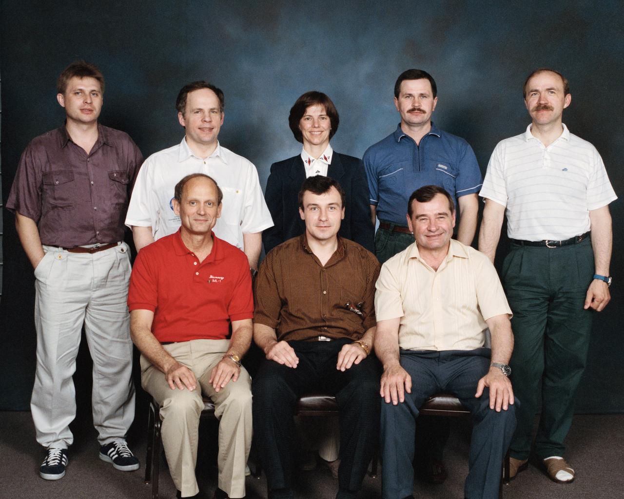 S94-35069 (17 June 1994) --- Crew members for the joint Space Shuttle/Mir missions pose for a team portrait in the midst of a three week training period at the Johnson Space Center (JSC).  On the front row are, left to right, astronaut Norman E. Thagard and cosmonauts Vladimir N. Dezhurov  and Gennadi M. Strekalov.  Back row, left to right, cosmonauts Yuri I. Onufrienko and Anatoly Y. Solovyov, astronaut Bonnie J. Dunbar, cosmonauts Nikolai M. Budarin and Alexander F. Poleshchuk.