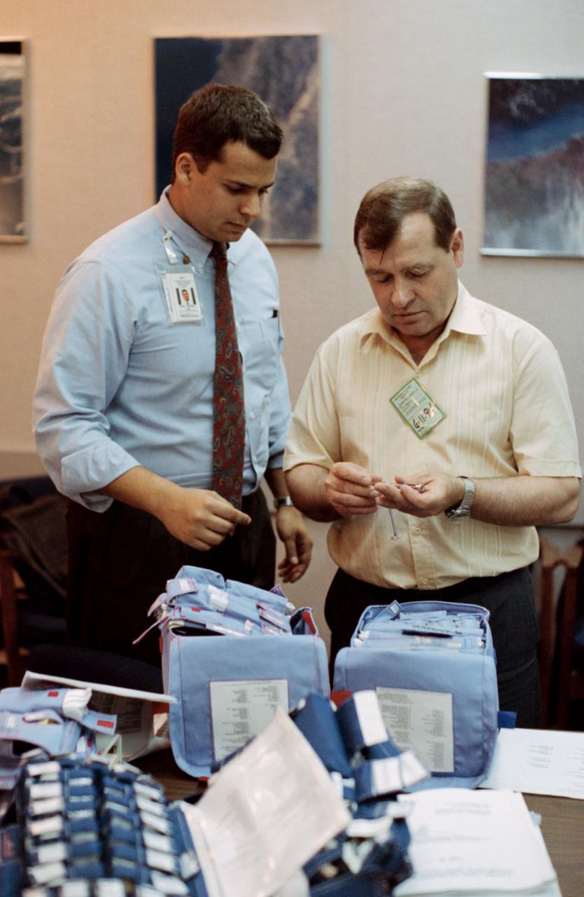 Cosmonaut Gennadiy M. Strekalov (right), Mir-18 flight engineer, is briefed on medical supplies by Ezra D. Kucharz, medical operations trainer for Krug Life Sciences, Incorporated. Strekalov and a number of other cosmonauts and astronauts participating in joint Russia - United States space missions are in Houston, Texas, to prepare for their upcoming missions.