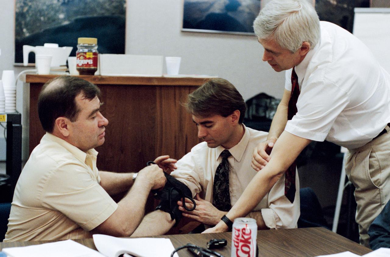 Using Dr. Dave E. Ward, a JSC physician, as a test subject, cosmonaut Gennadiy M. Strekalov (left), rehearses the taking of blood pressure. This is a service he will likely be performing a great deal next year when he boards Russia's Mir Space Station, in Earth-orbit, as Mir 18 flight engineer.