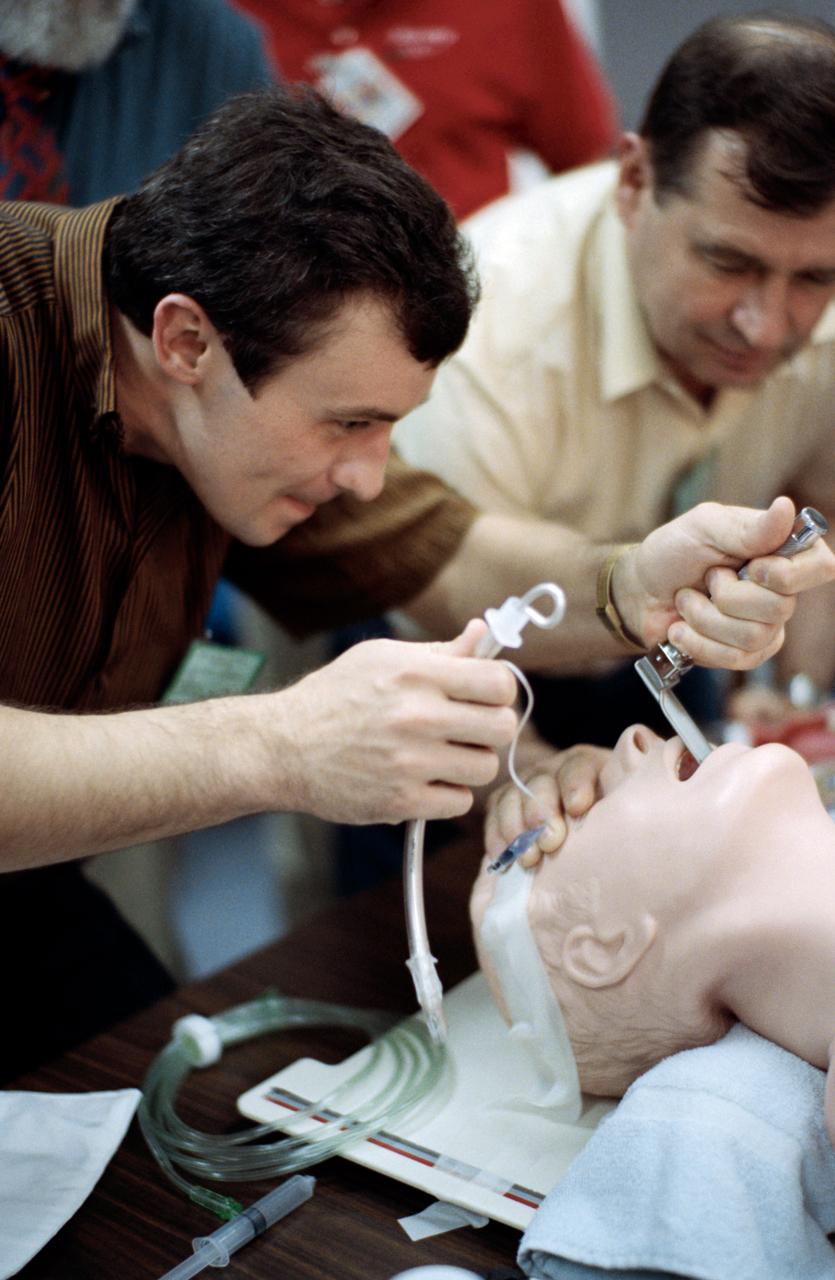 Cosmonaut Vladimir N. Dezhurov (left), Mir 18 mission commander, among a group of Russians in the United States to participate in training for the joint Russia - United States space missions, conducts an intubation on a dummy. Dezhurov, along with Mir 18 flight engineer Gennadiy M. Strekalov (pictured) prepare for upcoming missions which involve crew members from the two nations.